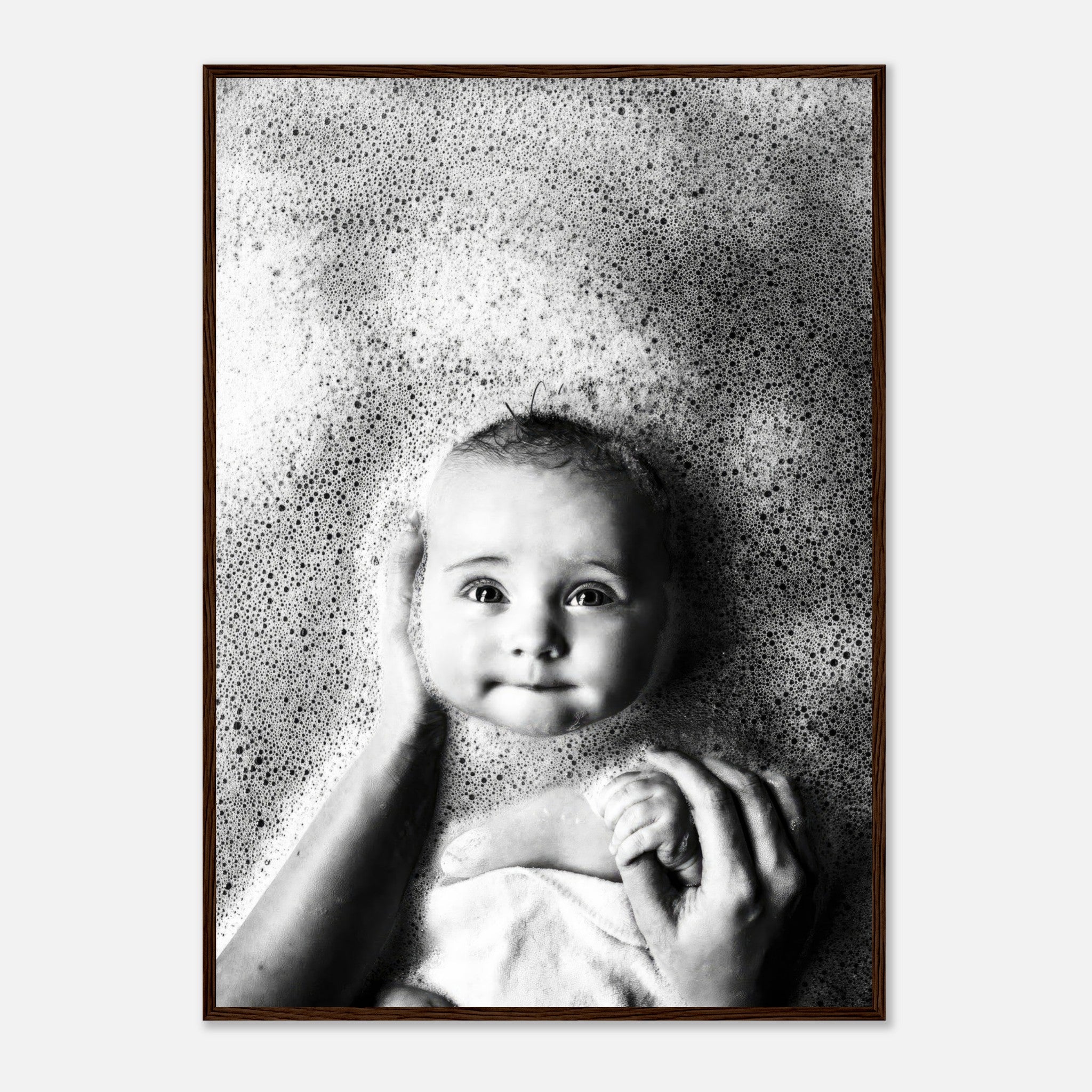 Black-and-white framed print of a baby enjoying bath time, surrounded by bubbles with a serene expression.