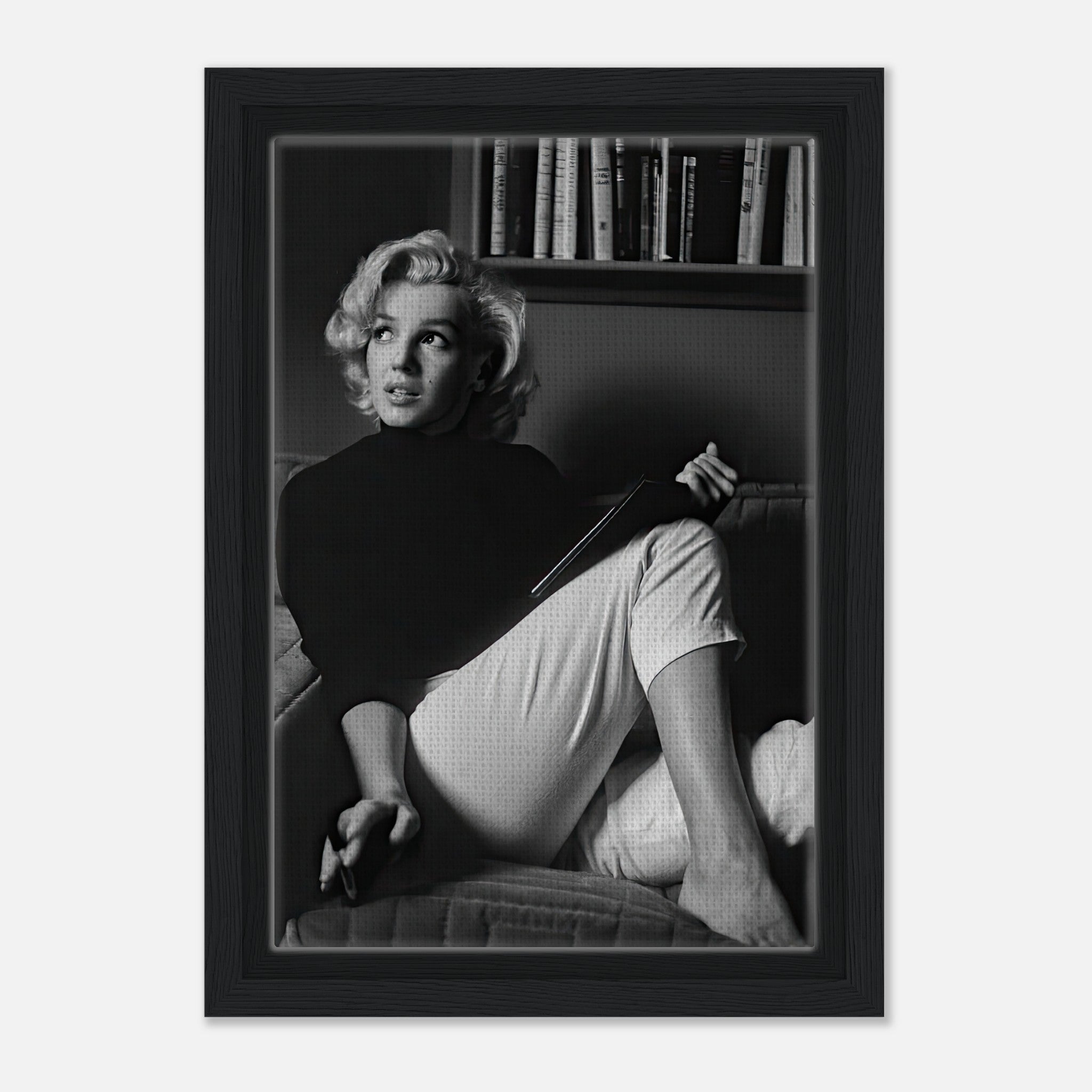 Marilyn Monroe framed canvas print reading a book, showcasing elegance in black and white decor.