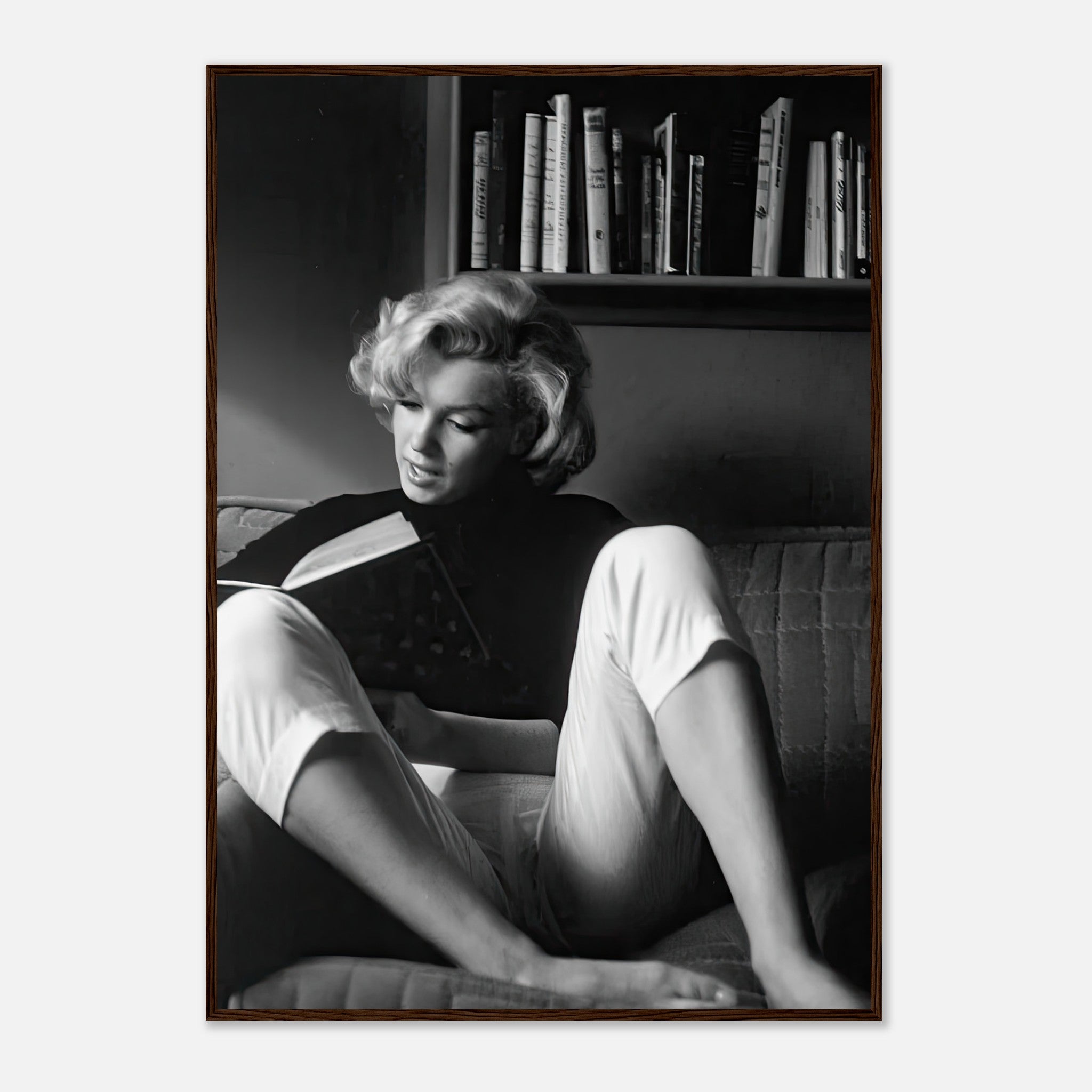 Marilyn Monroe reading at home, framed black-and-white print showcasing Hollywood glamour and sophistication.
