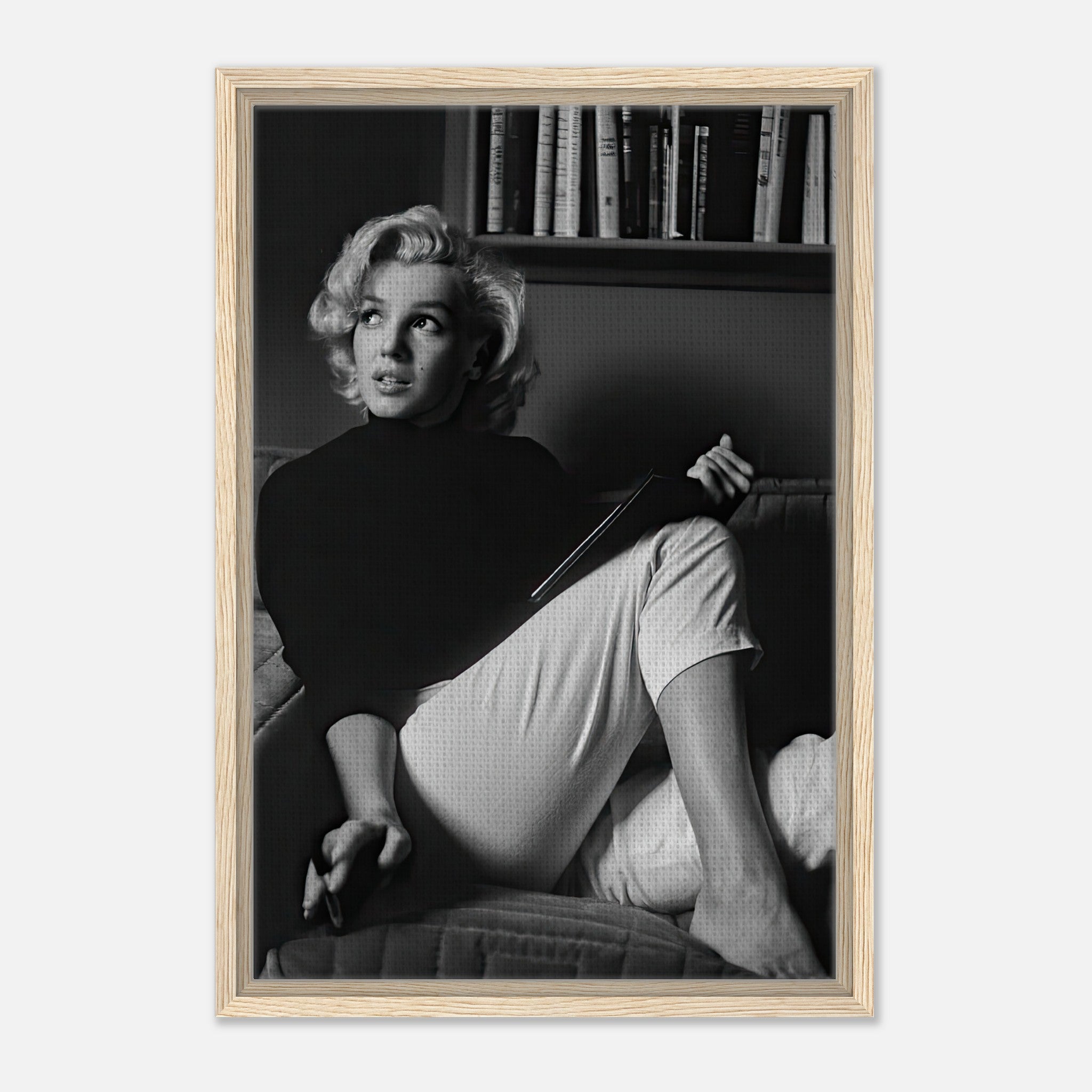 Marilyn Monroe reading a book, framed canvas print in black and white, showcasing elegance and charm.