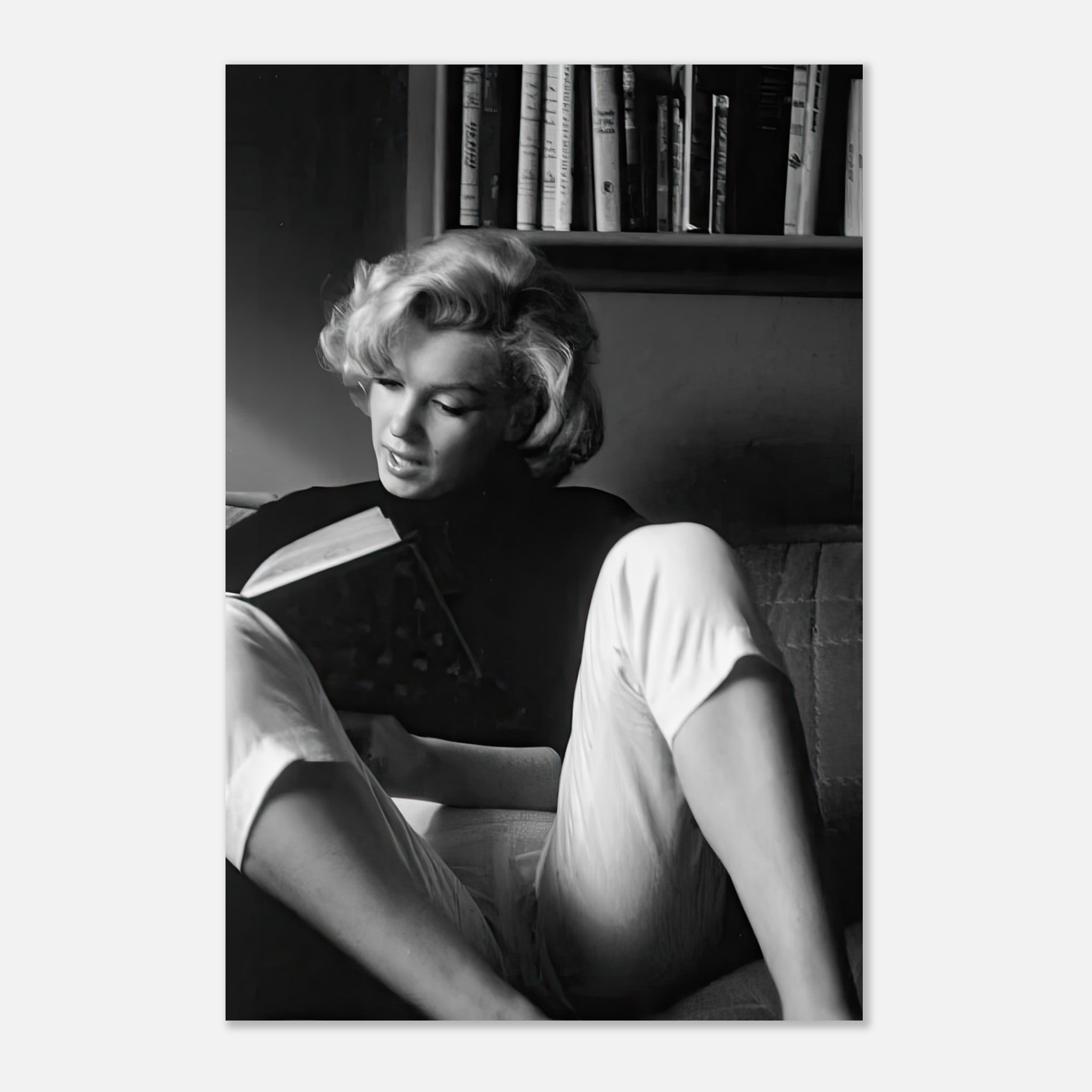 Marilyn Monroe reading a book at home, captured in a classic black-and-white metal print.