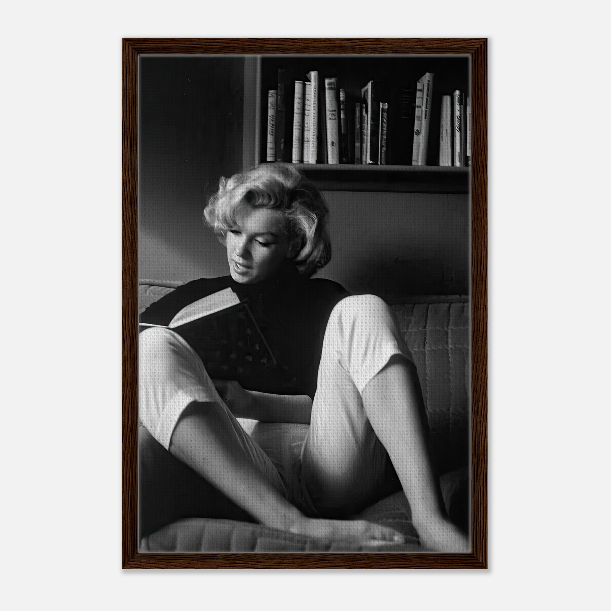 Marilyn Monroe reading at home, framed black-and-white canvas art, showcasing elegance and timeless allure.