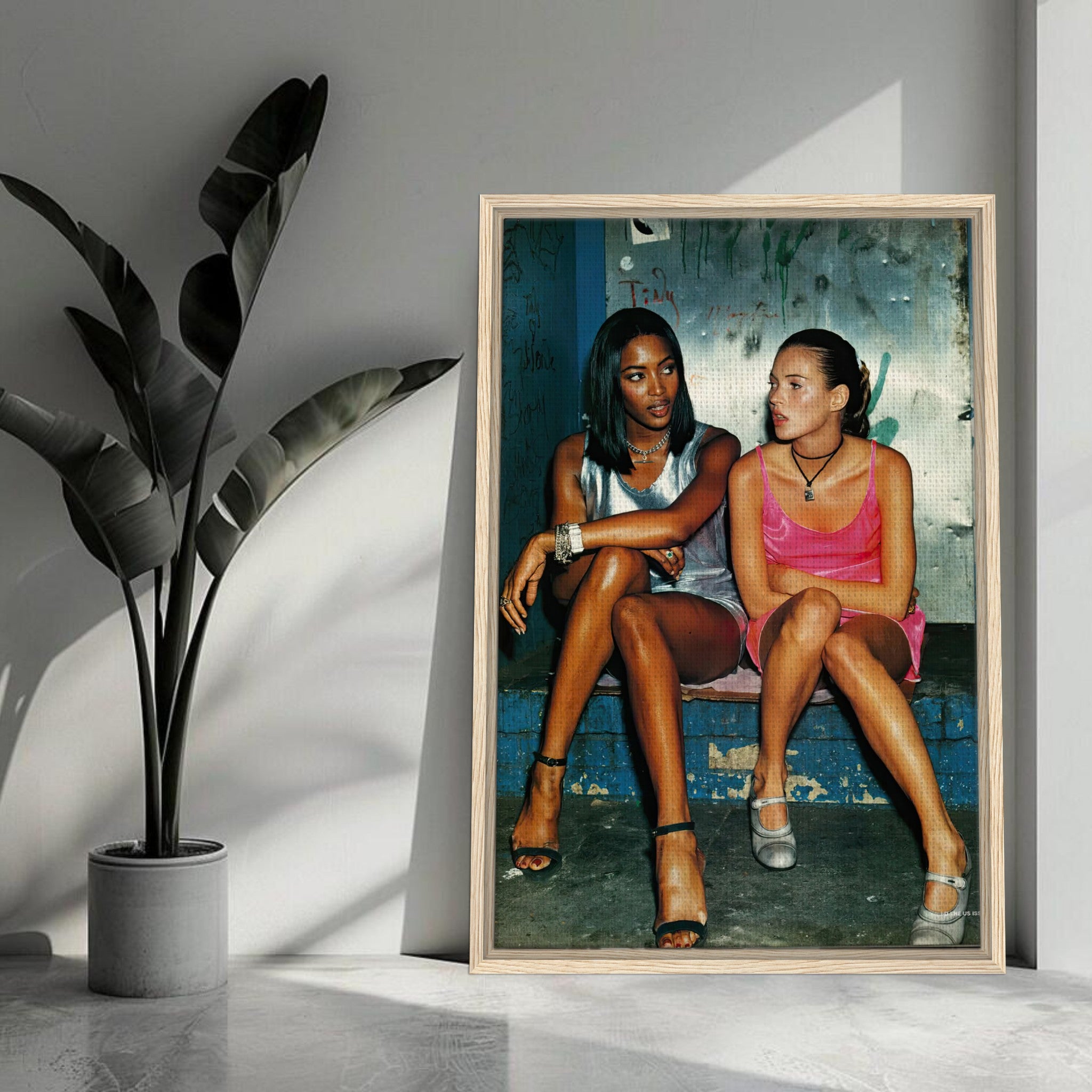 Naomi Campbell and Kate Moss framed canvas print capturing 90s supermodel glamour in a candid moment.