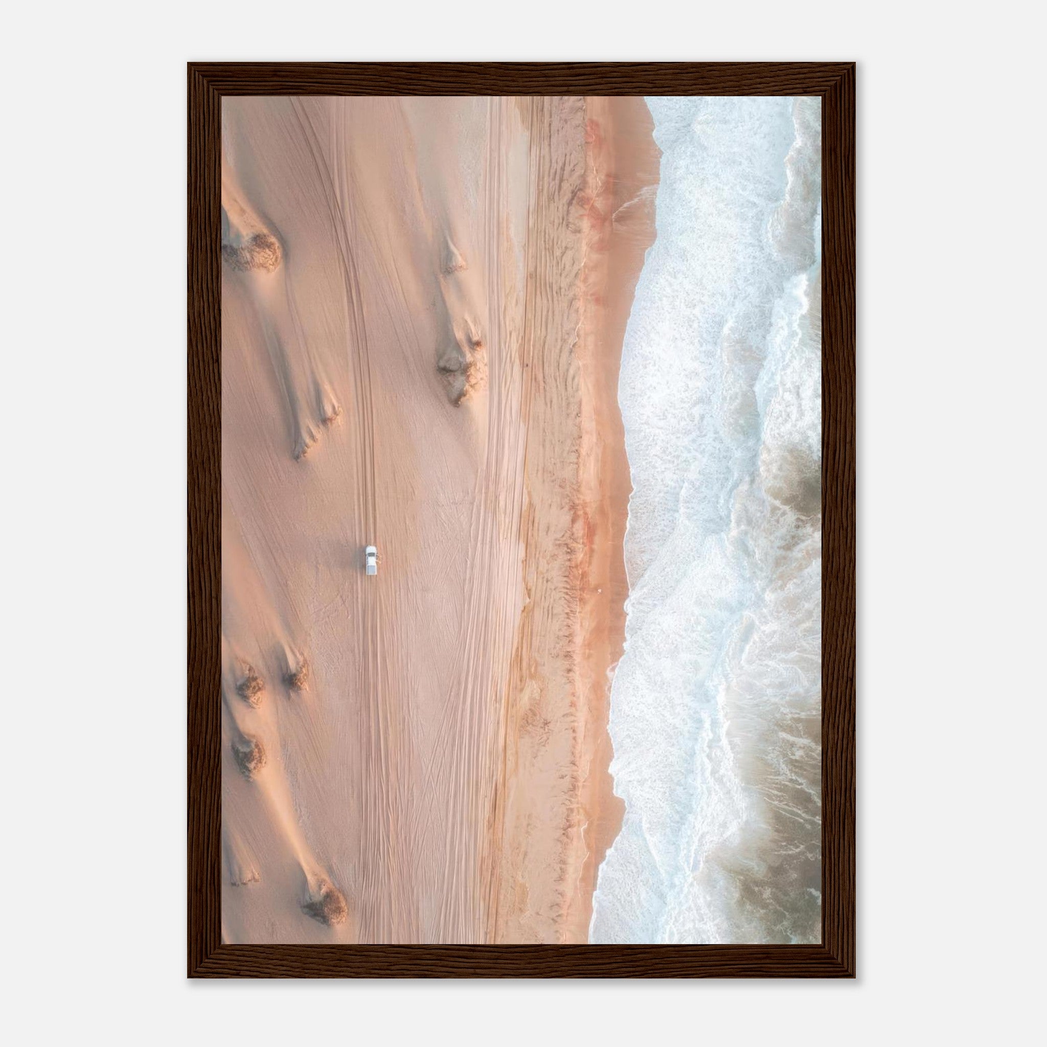 Stunning aerial view of sand dunes meeting ocean waves in a framed print, capturing nature's contrasting beauty.