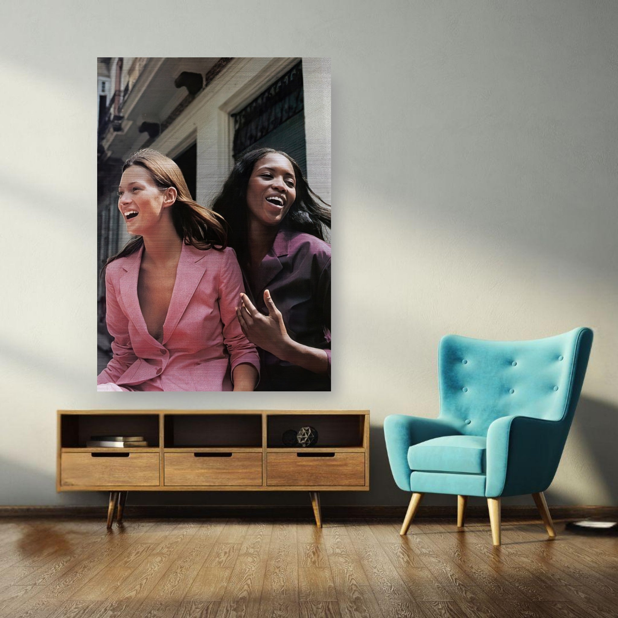 Naomi Campbell and Kate Moss laughing together in a brushed metal print, adding elegance to any space.