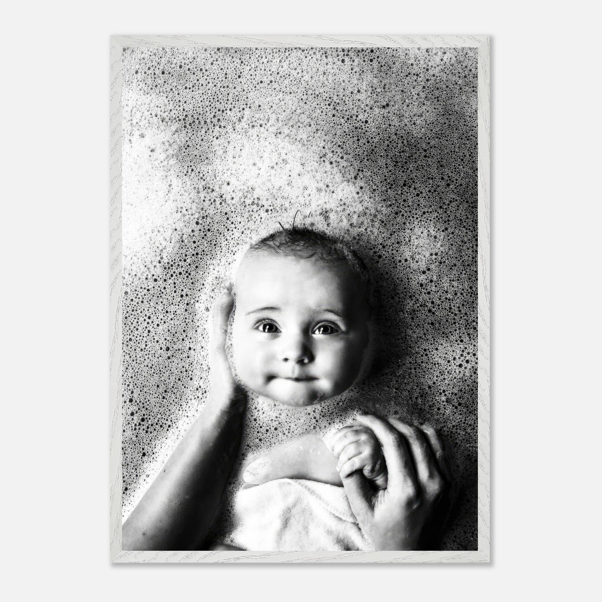 Black-and-white fine art baby bath photography capturing innocence and joy with soft bubbles and tender emotion.