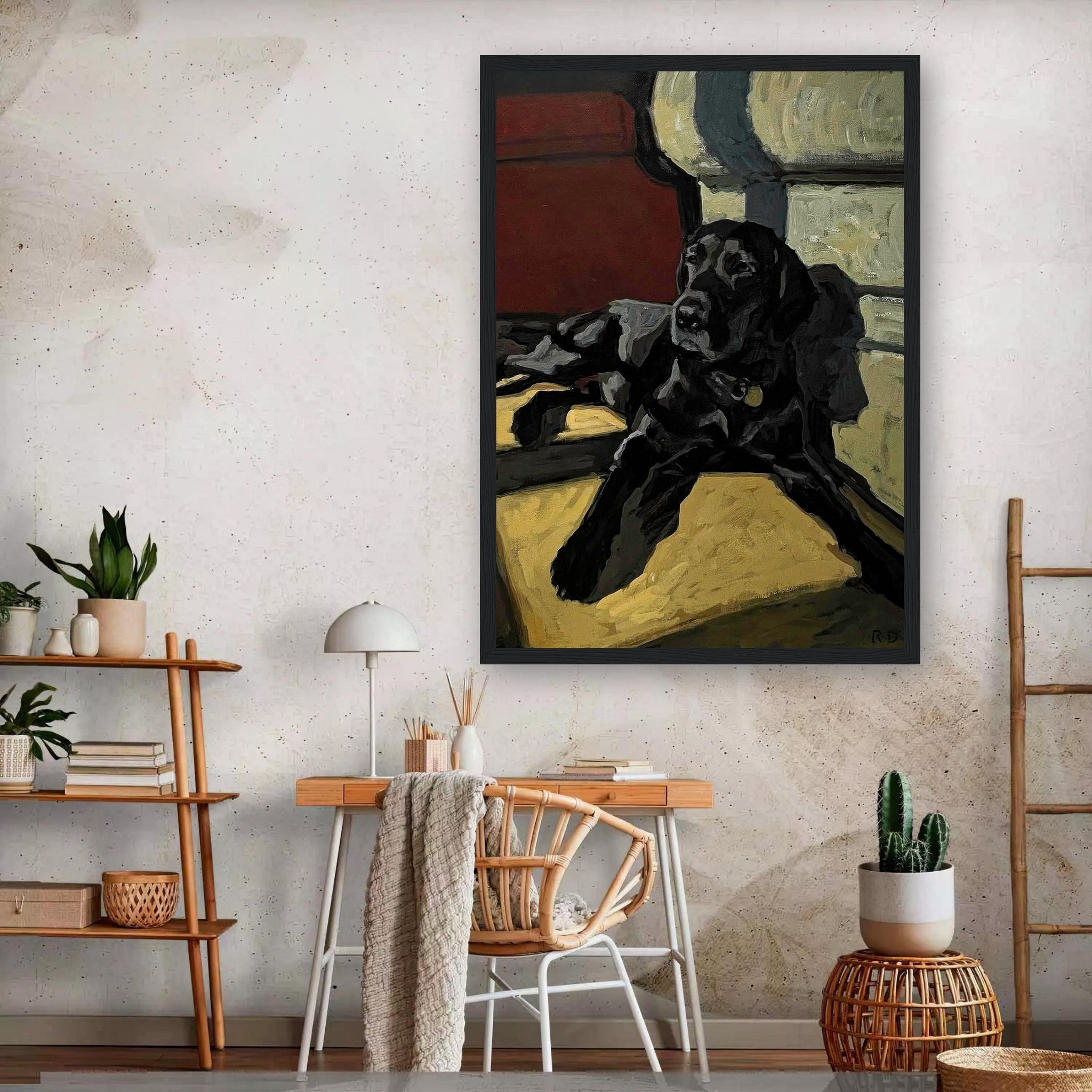 Framed print of a black Labrador dog lounging in a cozy indoor setting, adding warmth to home decor.