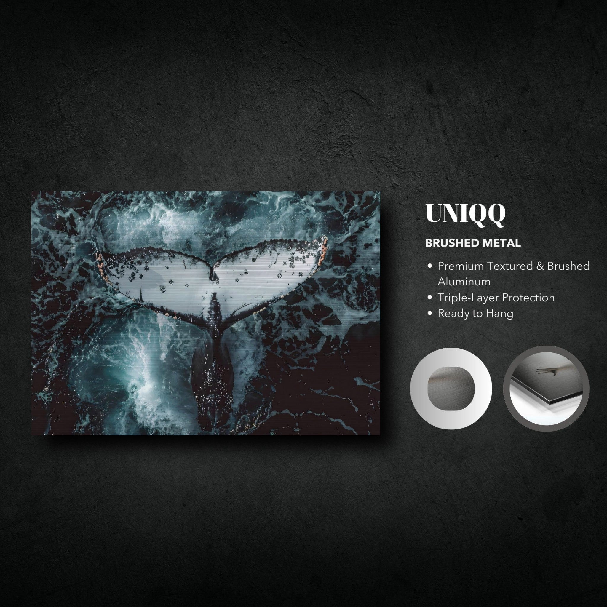 Humpback whale tail print on brushed metal, showcasing detailed marine art against ocean waves.