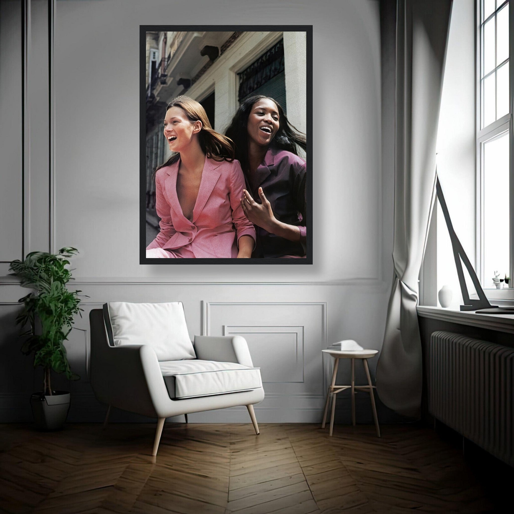 Framed print of Naomi Campbell and Kate Moss laughing, showcasing timeless fashion elegance in a stylish interior.