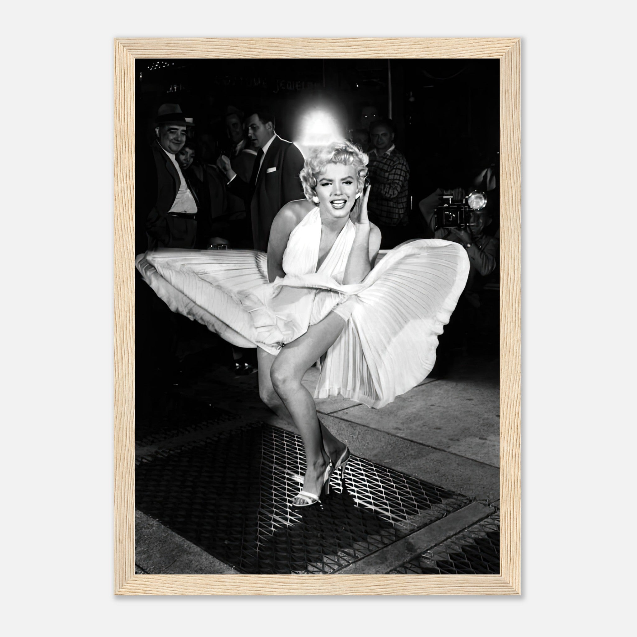 Framed photograph of Marilyn Monroe in a white dress, playfully posed over a subway grate in classic Hollywood style.