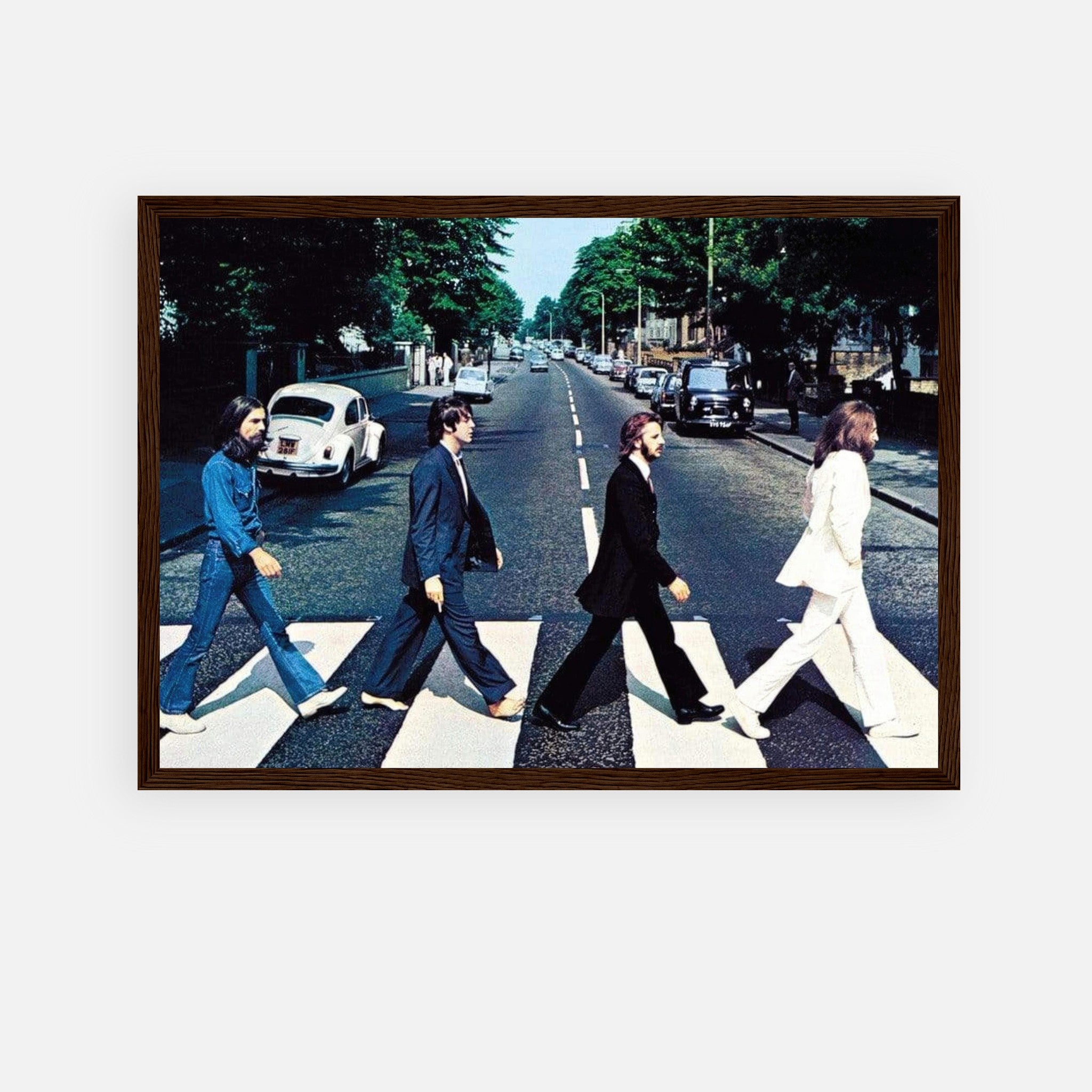 Framed print of The Beatles walking on Abbey Road, capturing iconic music history.