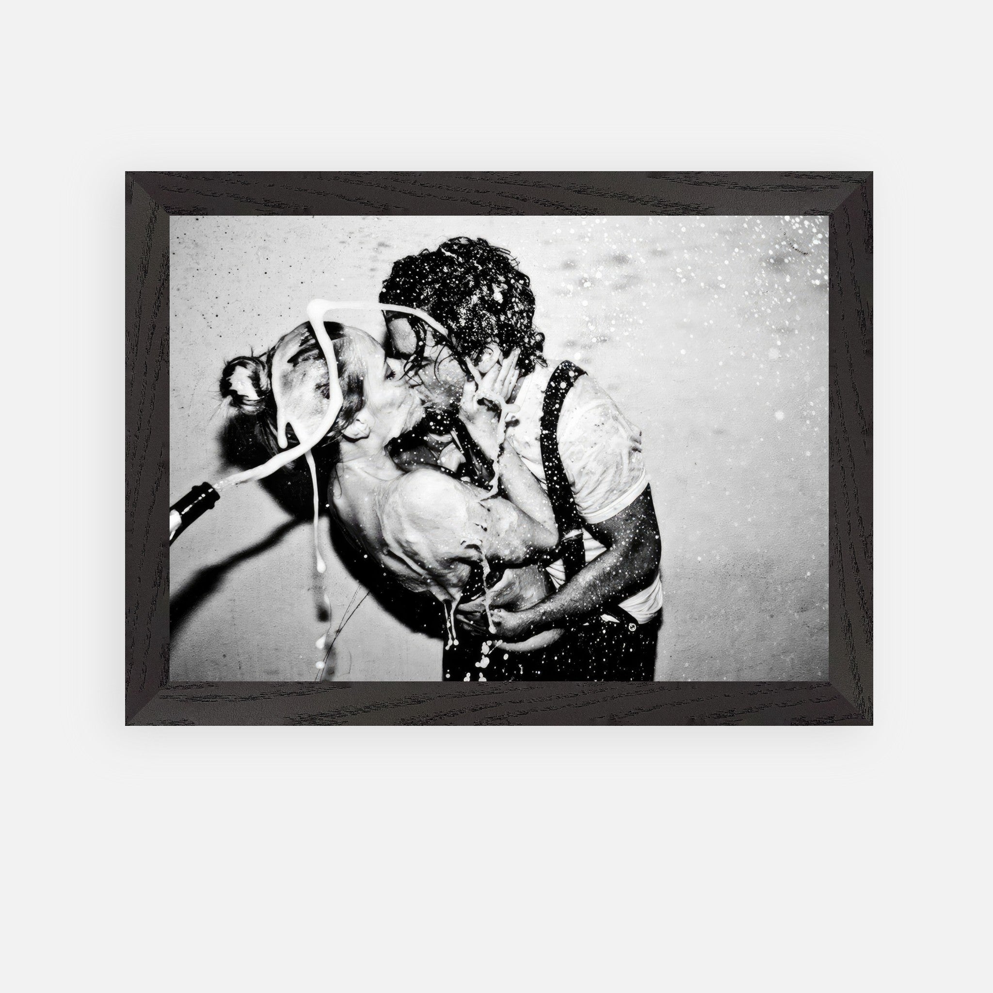 The Champagne Kiss vintage framed art featuring a passionate kiss between Johnny Depp and Kate Moss with champagne.