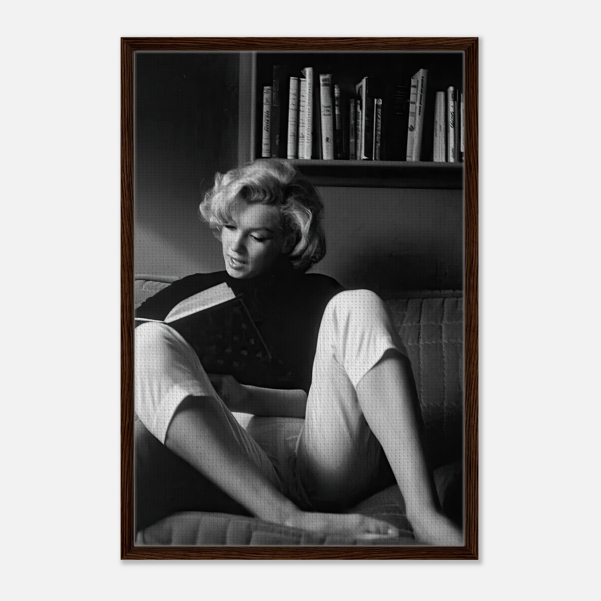 Marilyn Monroe reading a book at home, captured in black-and-white framed canvas artwork.
