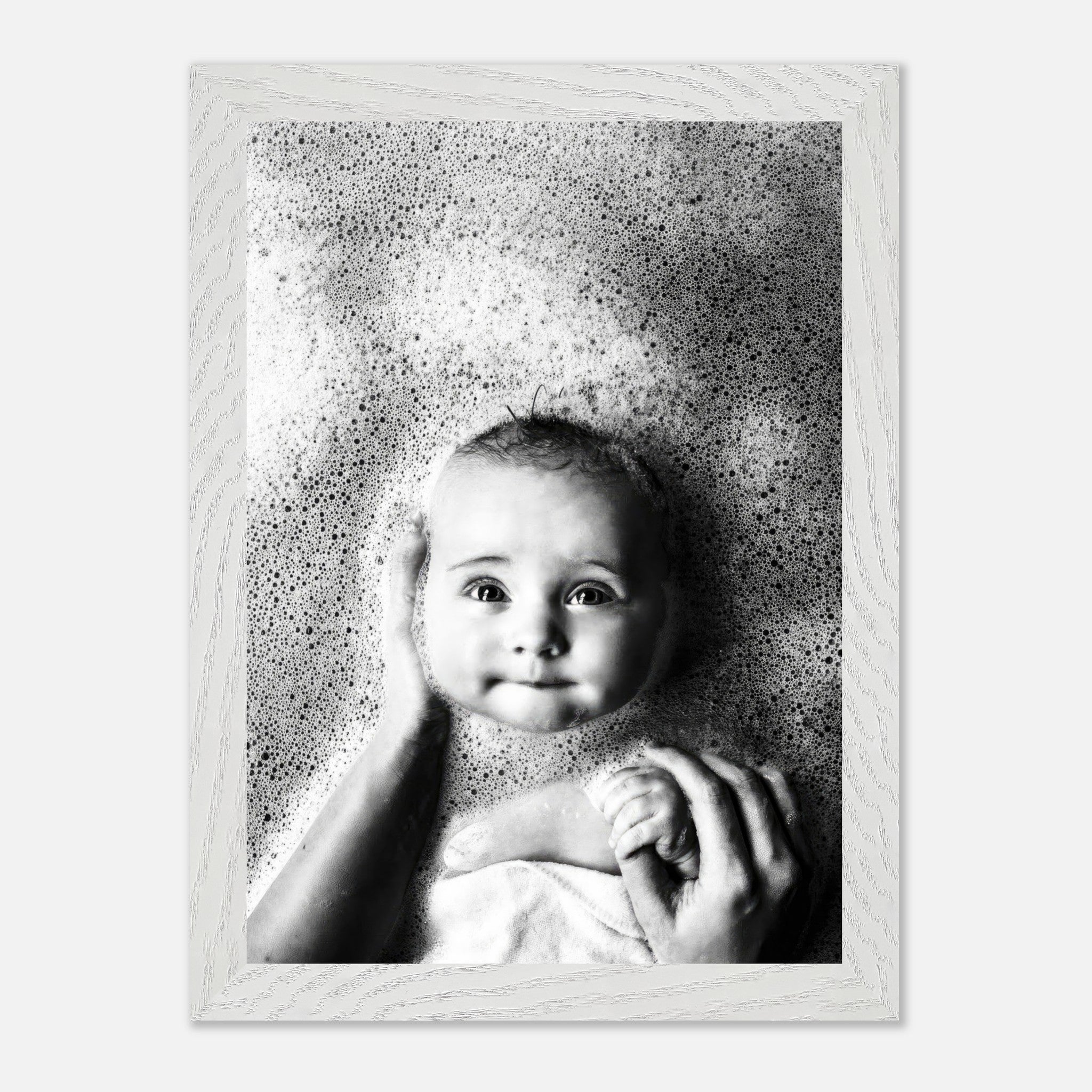 Vintage black and white photograph of a baby in a bubble bath, showcasing innocence and nostalgia.