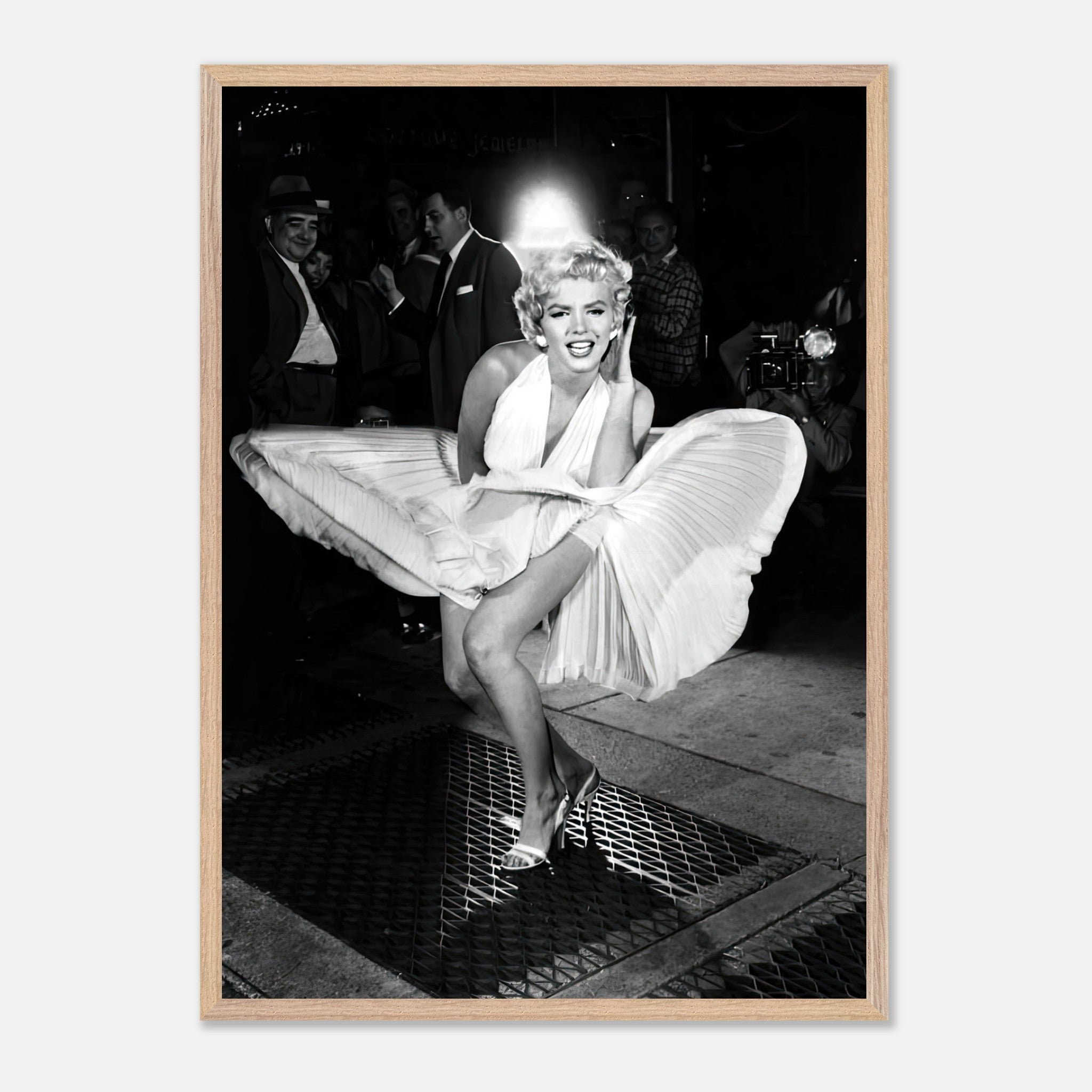 Marilyn Monroe in a white dress caught in wind, vintage framed print capturing Hollywood glamour.