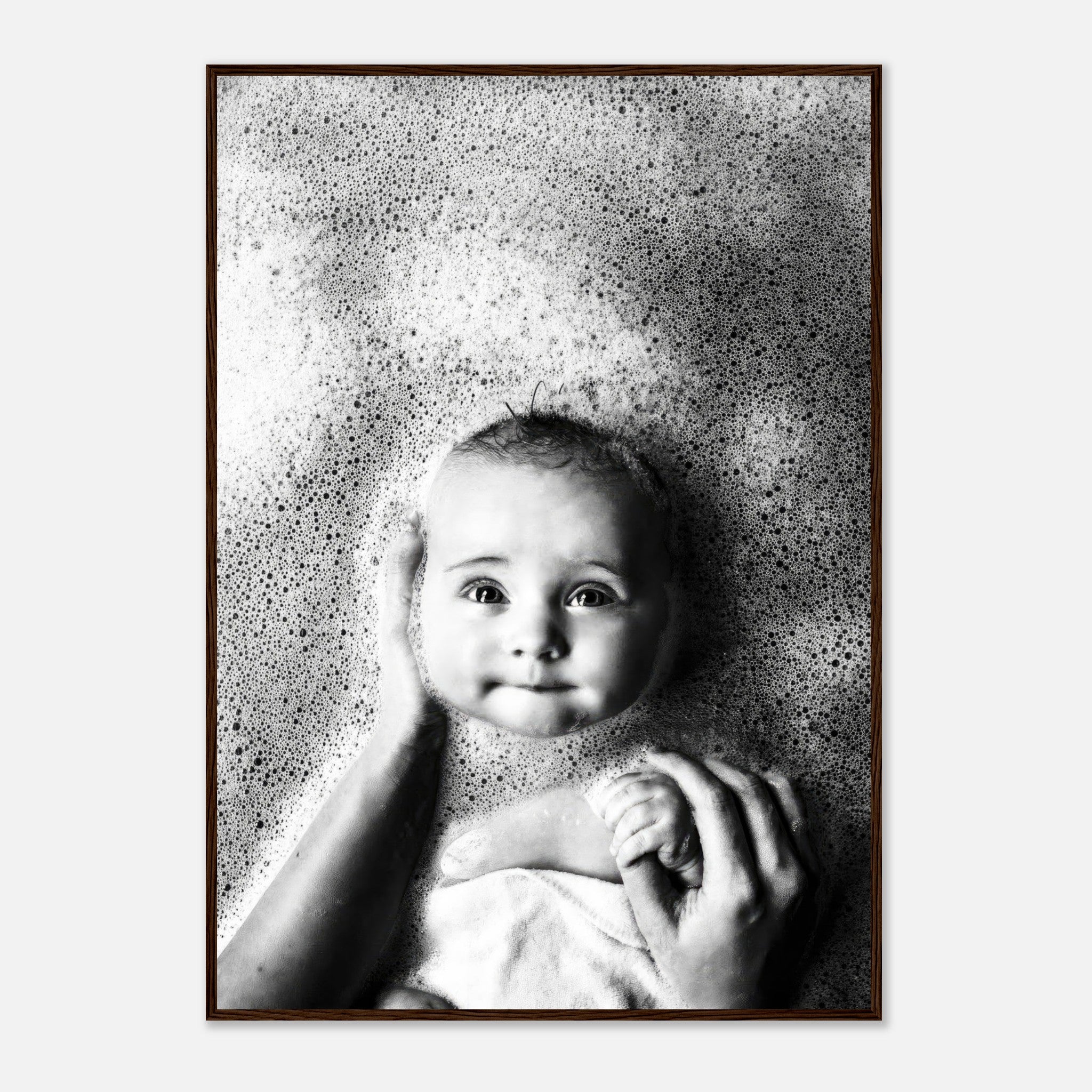 Baby bath photography framed print showcasing a serene baby surrounded by bubbles in a black-and-white image.