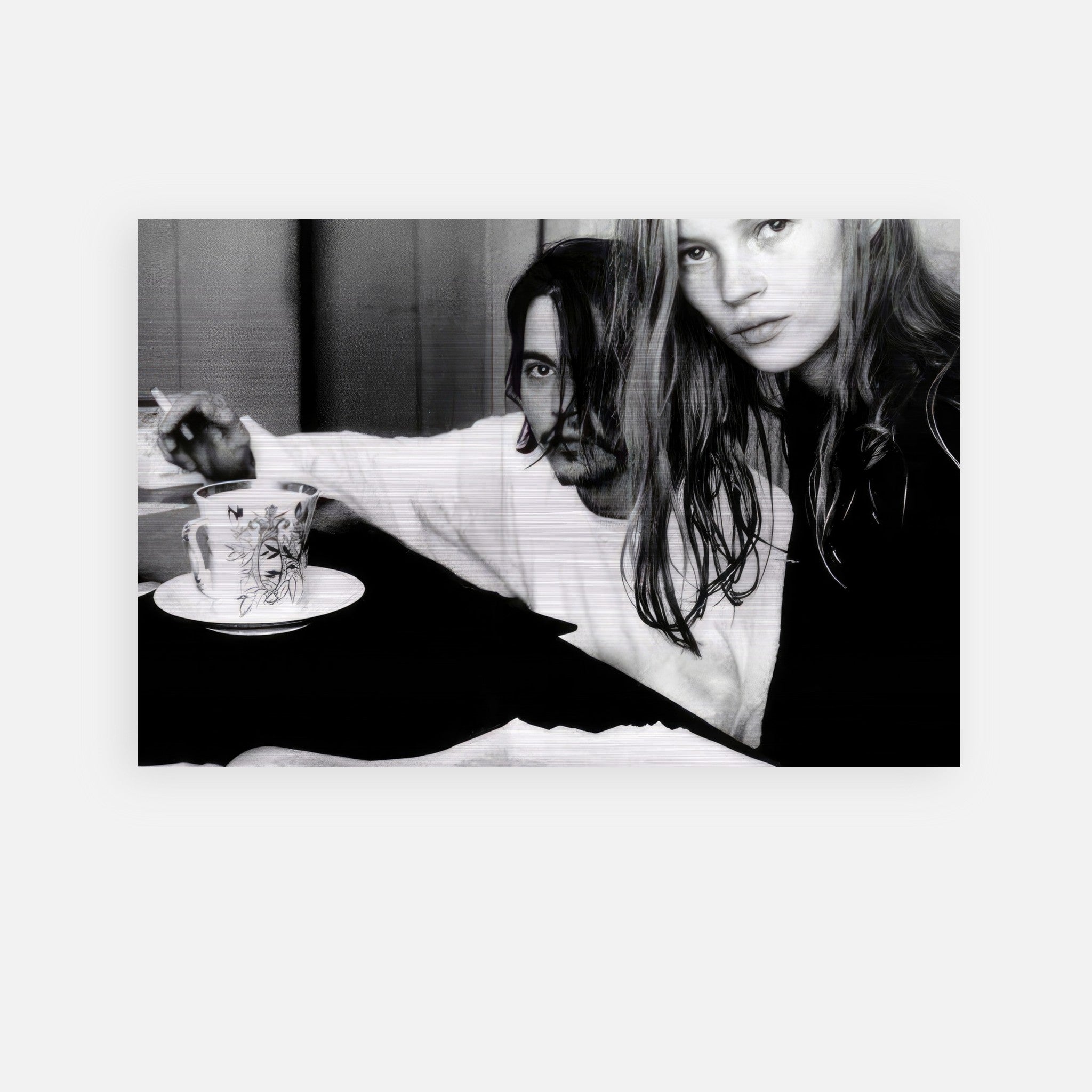Johnny Depp and Kate Moss in a black and white intimate moment, showcasing 1990s rebel romance, brushed metal print.