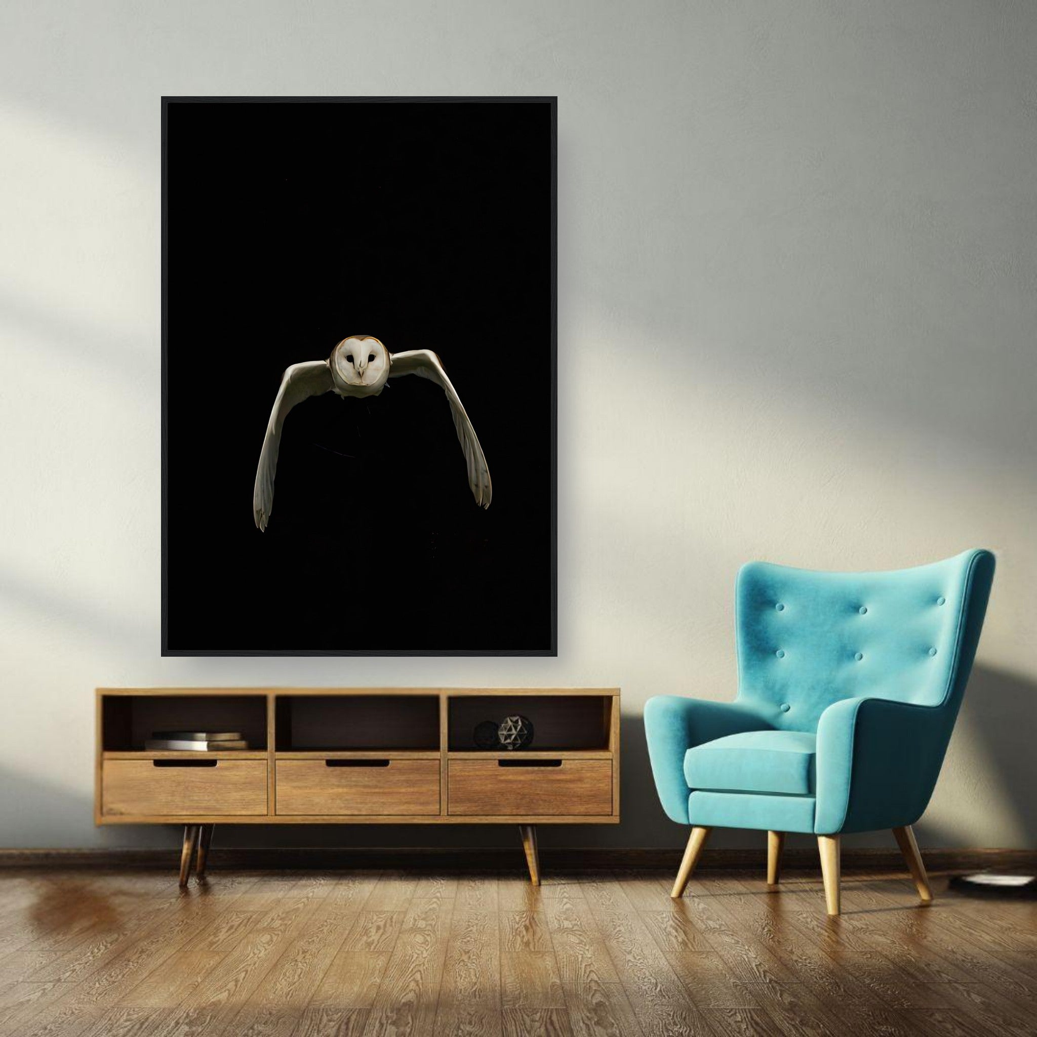 Owl Framed Print featuring a barn owl in flight against a black background in a modern living room setting.