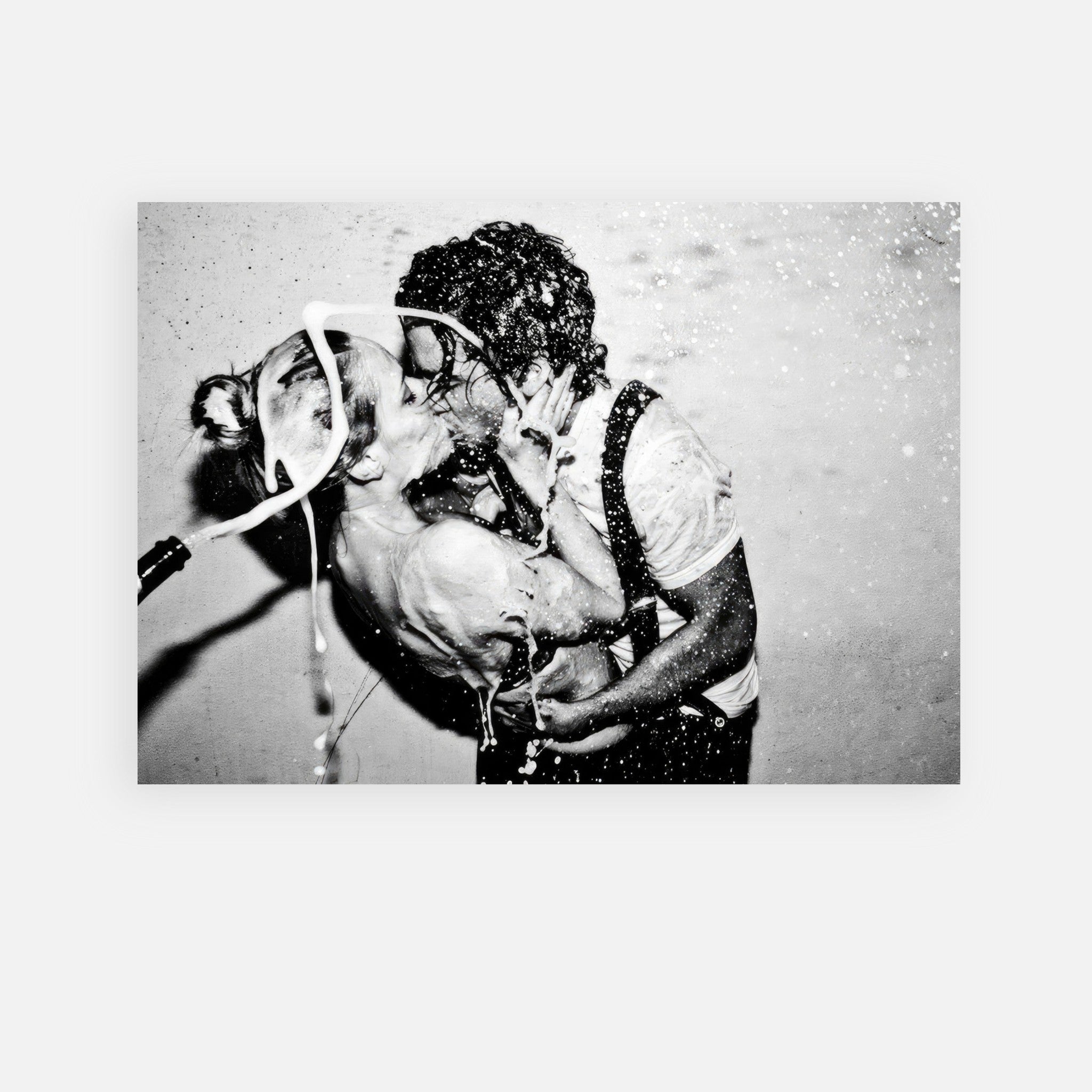 Black-and-white poster of Johnny Depp and Kate Moss sharing an intimate kiss with champagne splash.