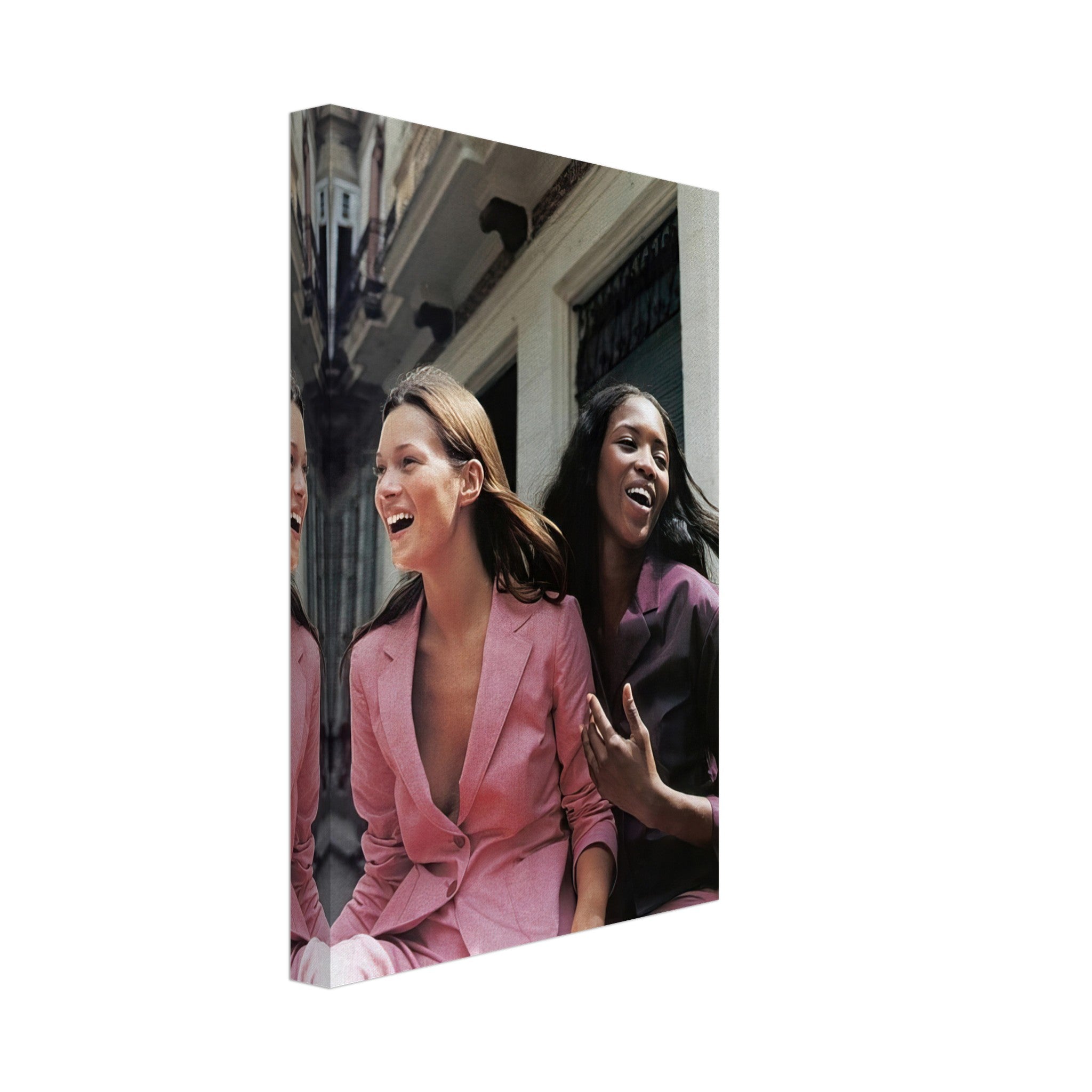 Naomi Campbell and Kate Moss laughing in stylish pink suits, captured in a vibrant canvas print celebrating fashion.