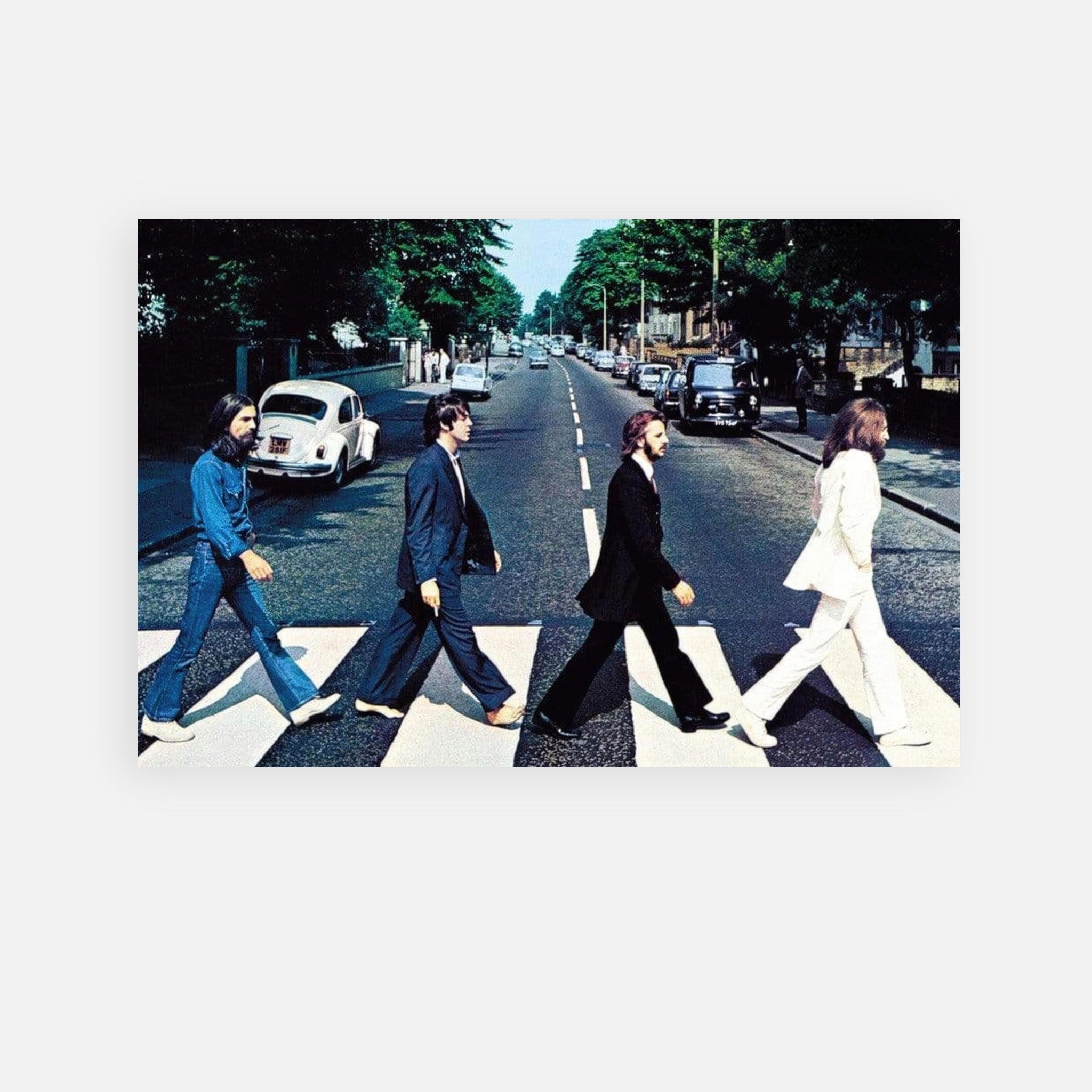 The Beatles Abbey Road Metal Print featuring iconic crossing scene with band members in black and white outfits.