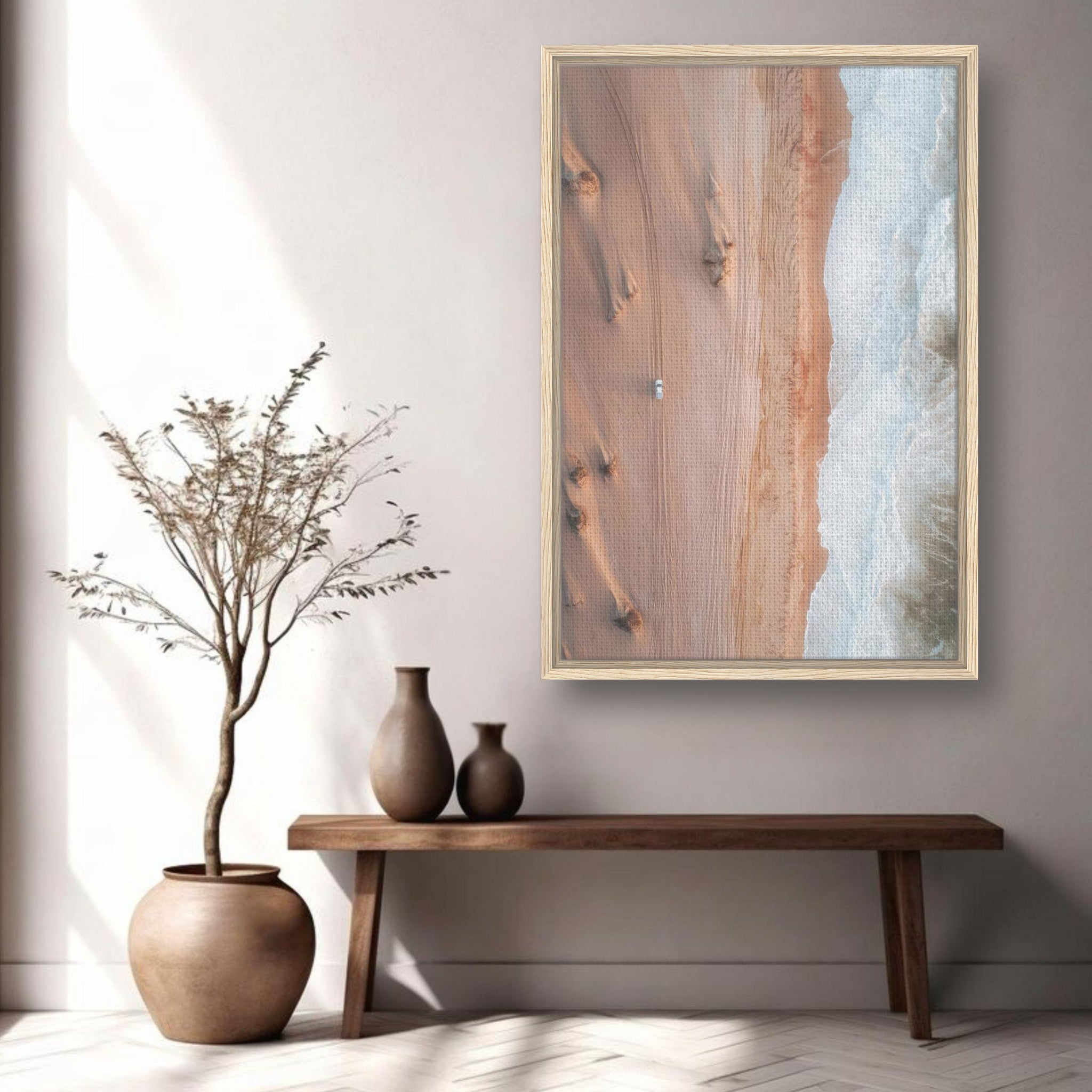 Framed drone photography canvas print showcasing desert and ocean textures in a serene home setting.