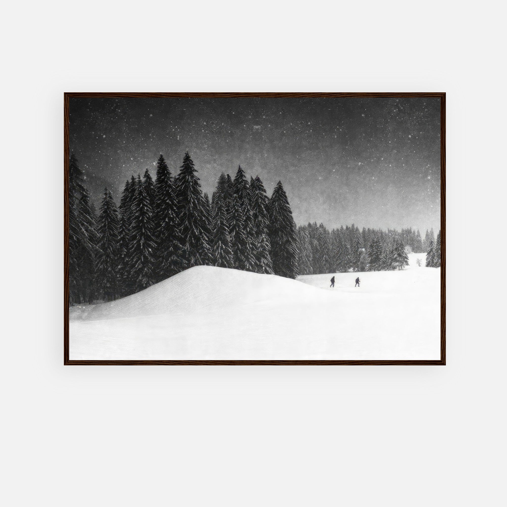 Winter Crossing framed print featuring a snow-covered forest and skiers, showcasing serene black-and-white photography.