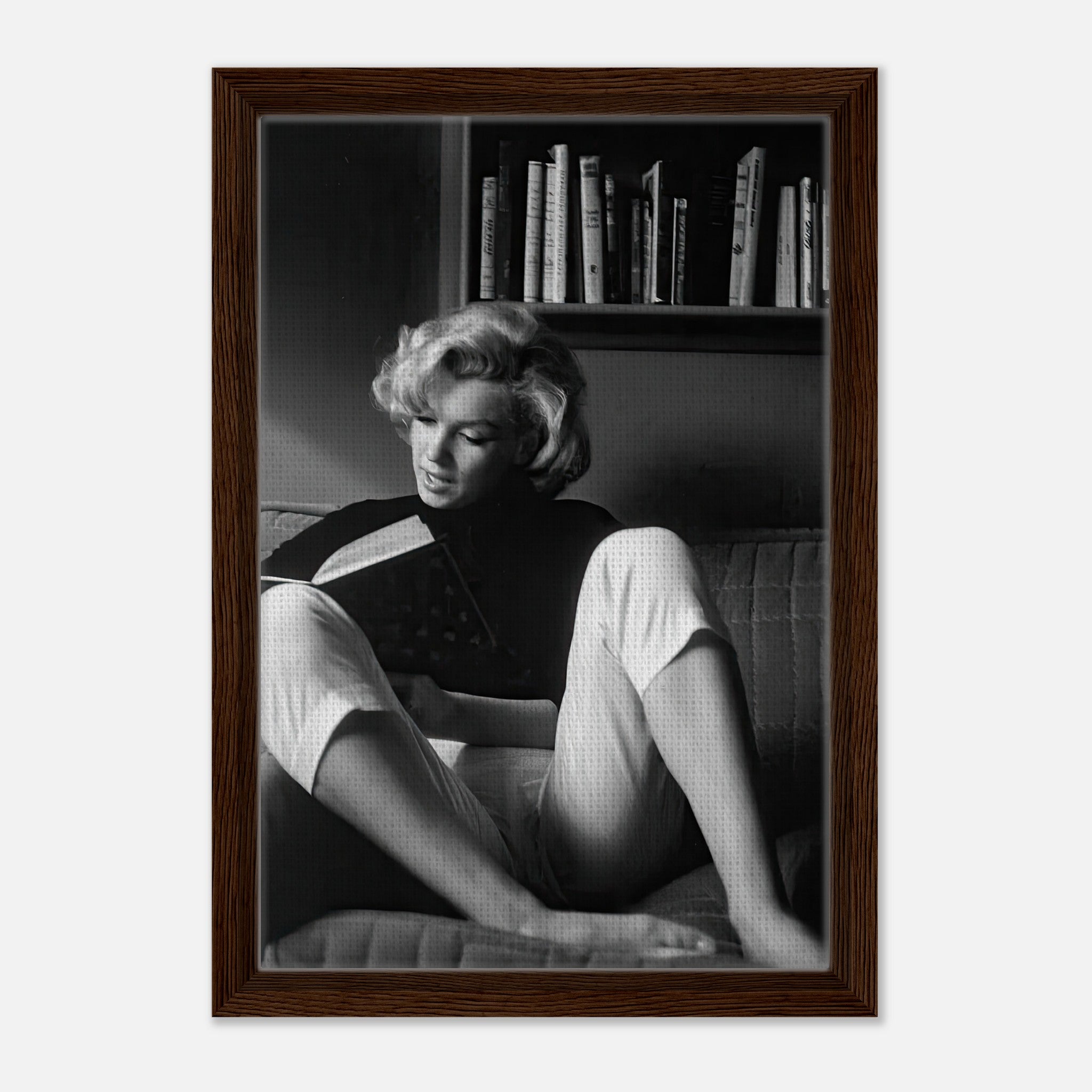 Marilyn Monroe reading at home in a framed black-and-white canvas, showcasing elegance and serenity.