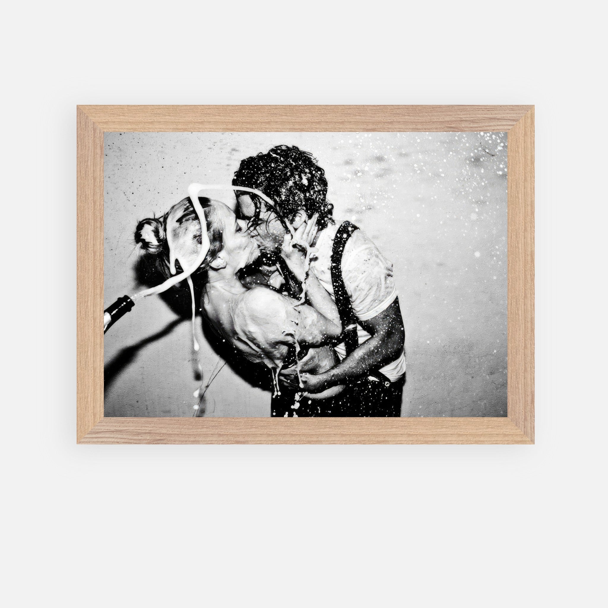 Vintage framed black-and-white art of Johnny Depp and Kate Moss sharing a champagne kiss, capturing raw romance.