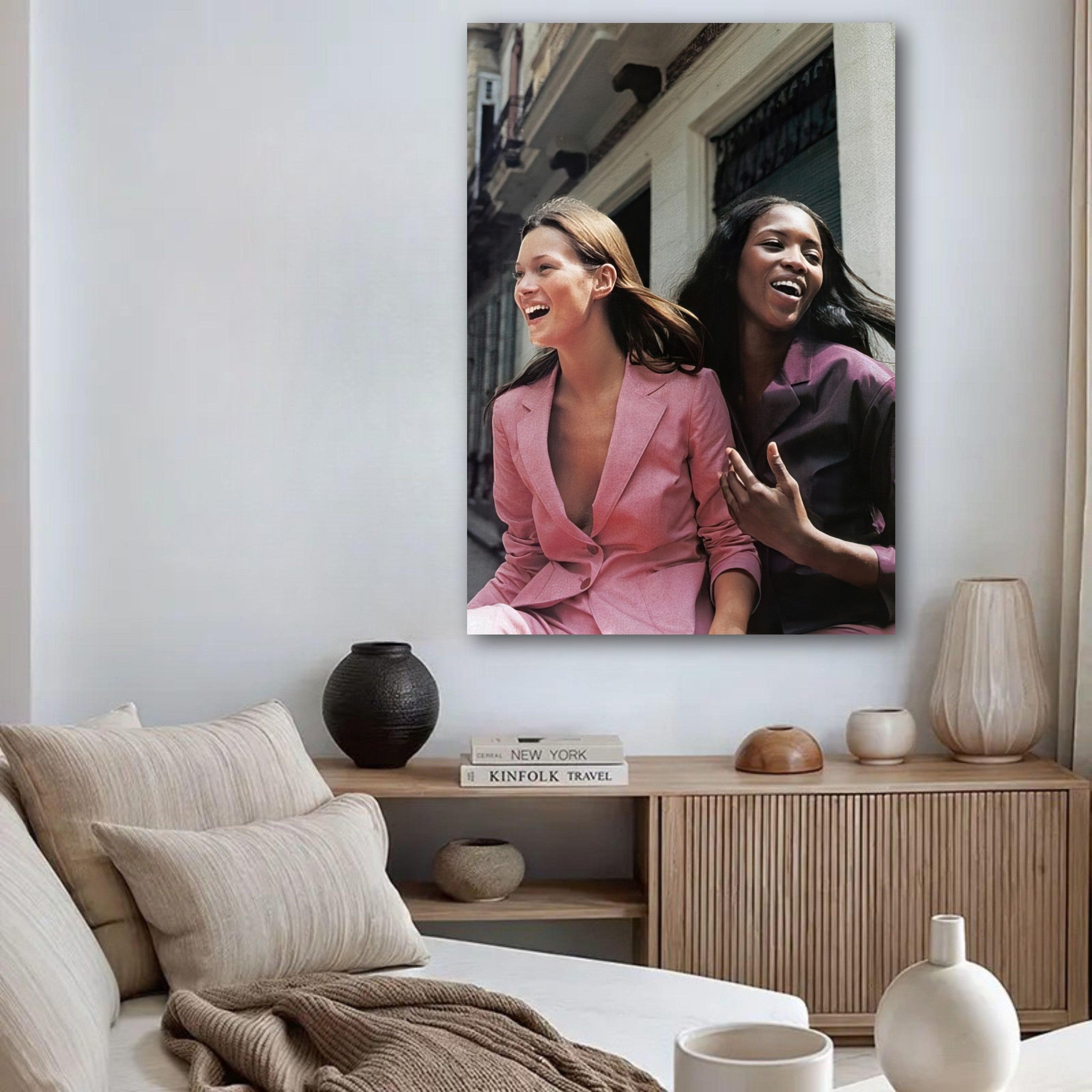 Naomi Campbell and Kate Moss poster showcasing effortless style and joy in a chic living room setting.