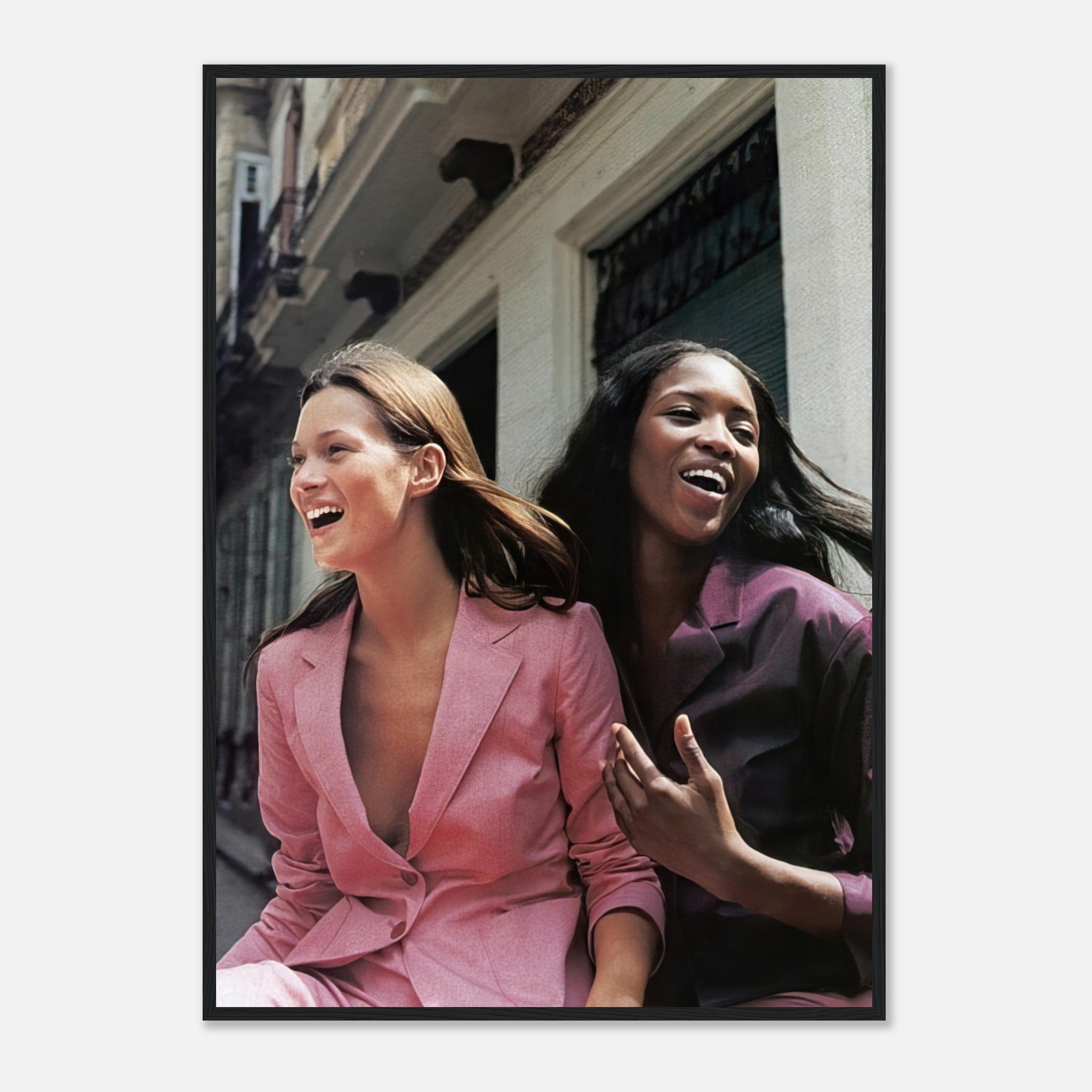 Naomi Campbell and Kate Moss candidly laughing in stylish pink outfits, stunning framed print capturing fashion heritage.