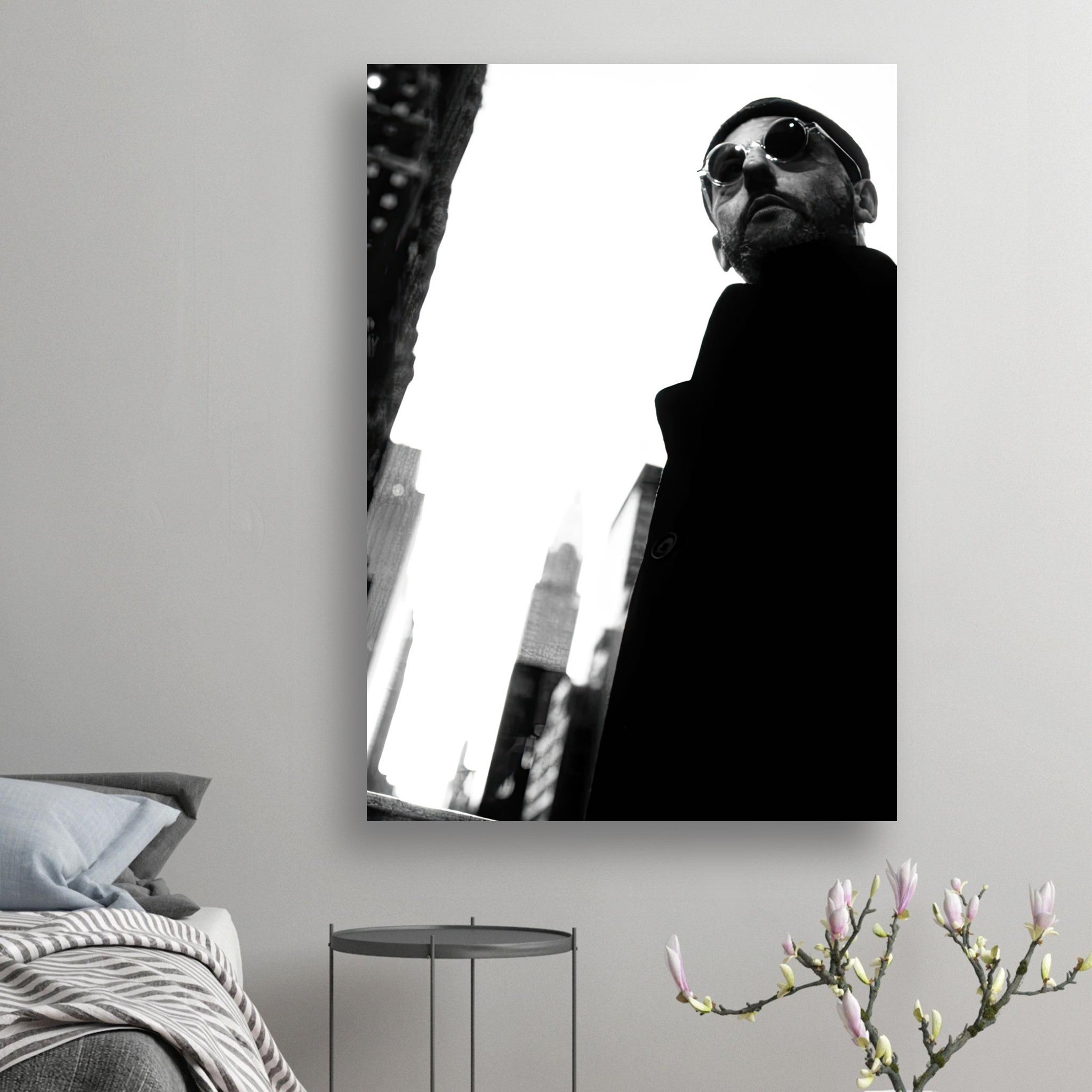 Black-and-white poster of Jean Reno with sunglasses, capturing cinematic artistry and style in a modern setting.