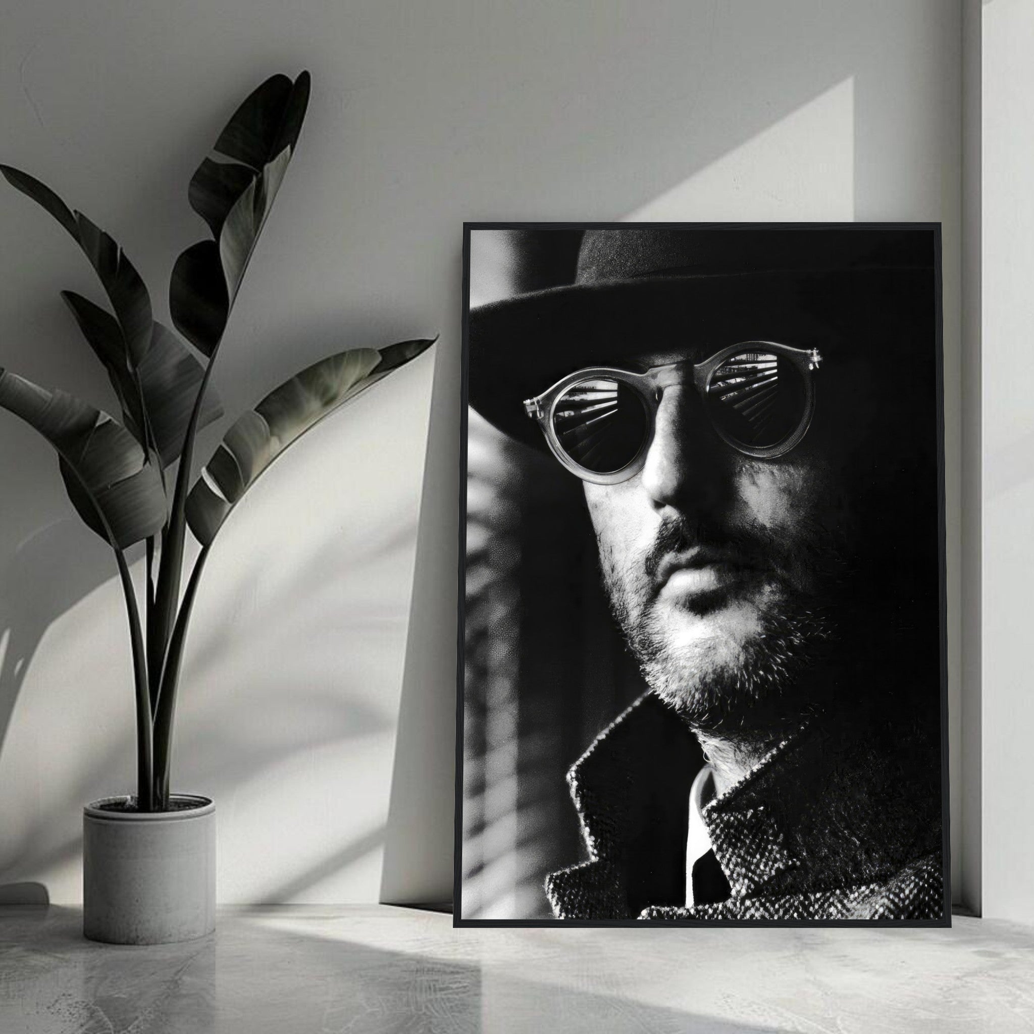 Black-and-white framed print of Jean Reno in sunglasses, adding sophistication and charm to any interior decor.