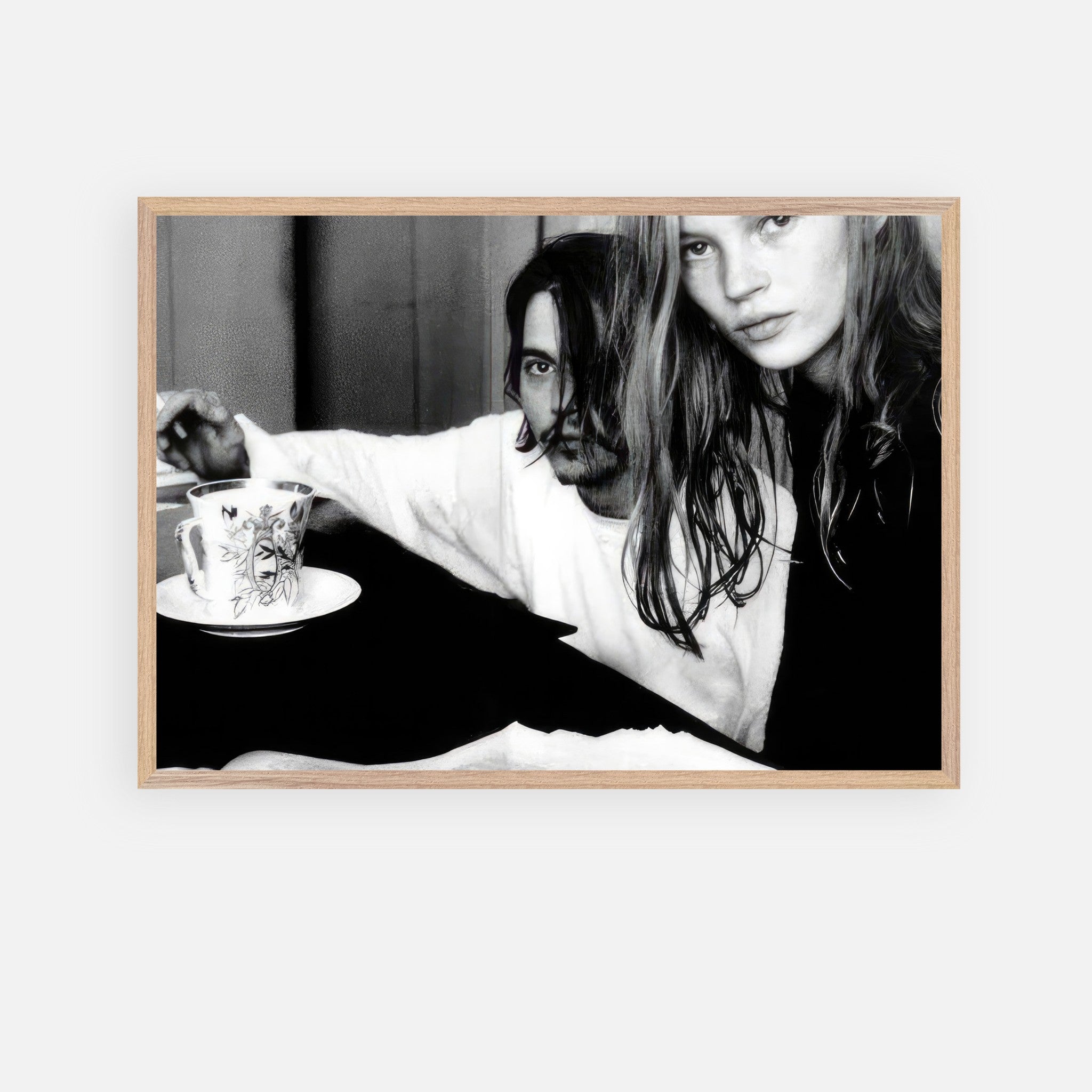 Vintage framed art of Johnny Depp and Kate Moss, capturing 90s romance and rebellion in black-and-white.