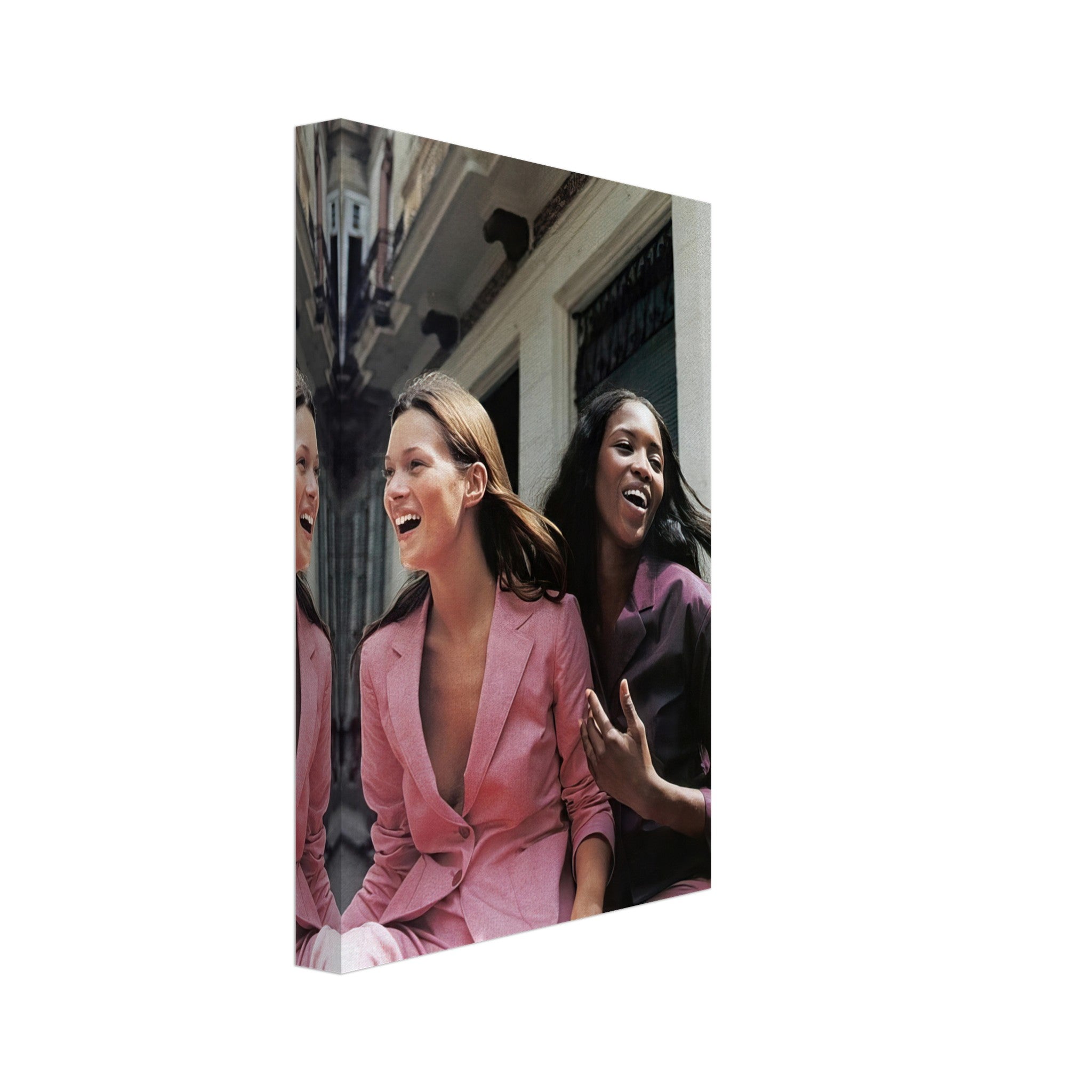 Naomi Campbell and Kate Moss laughing in stylish outfits, captured in a vibrant canvas print celebrating fashion.