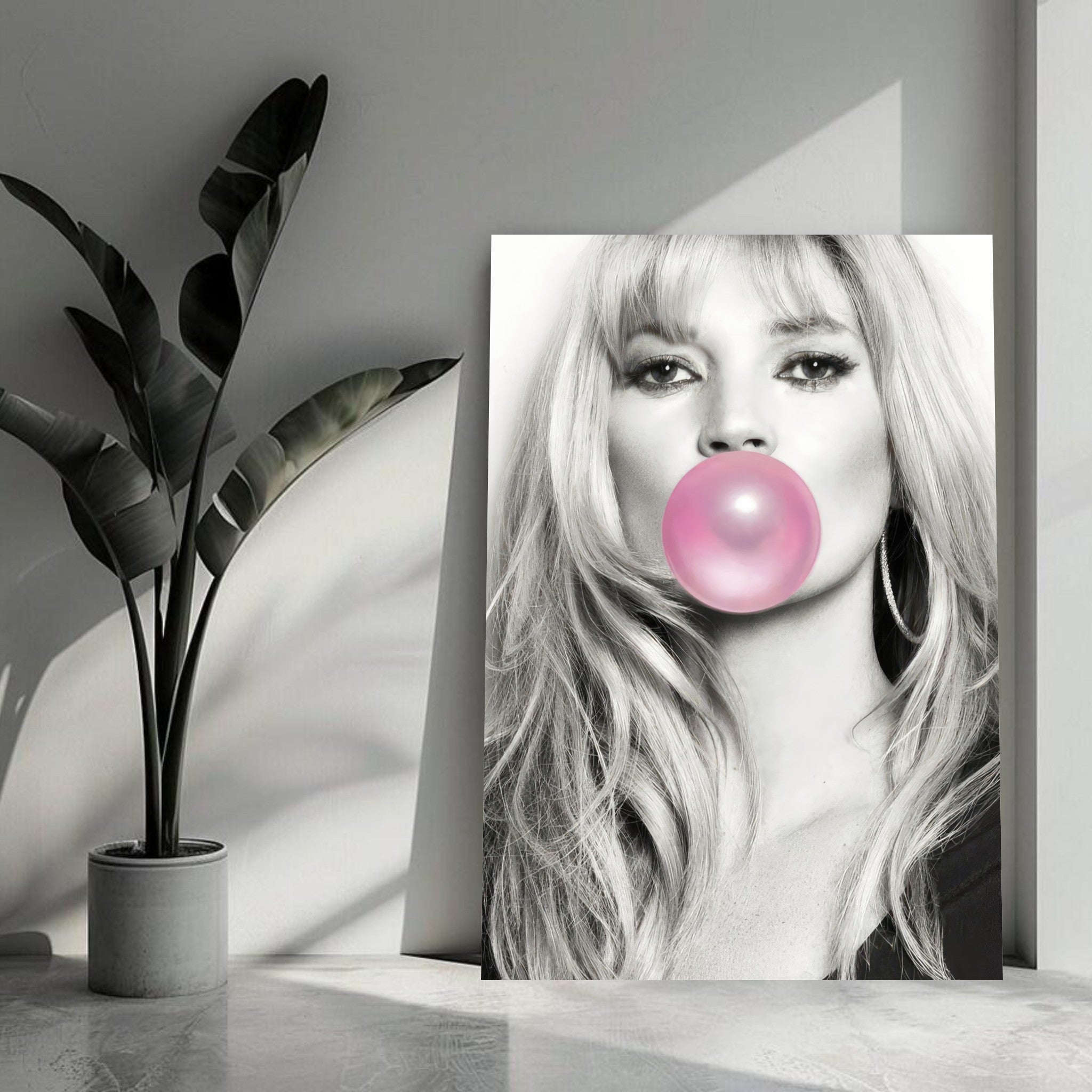 Kate Moss metal poster featuring a chic black-and-white portrait with pink bubble gum, perfect for modern decor.