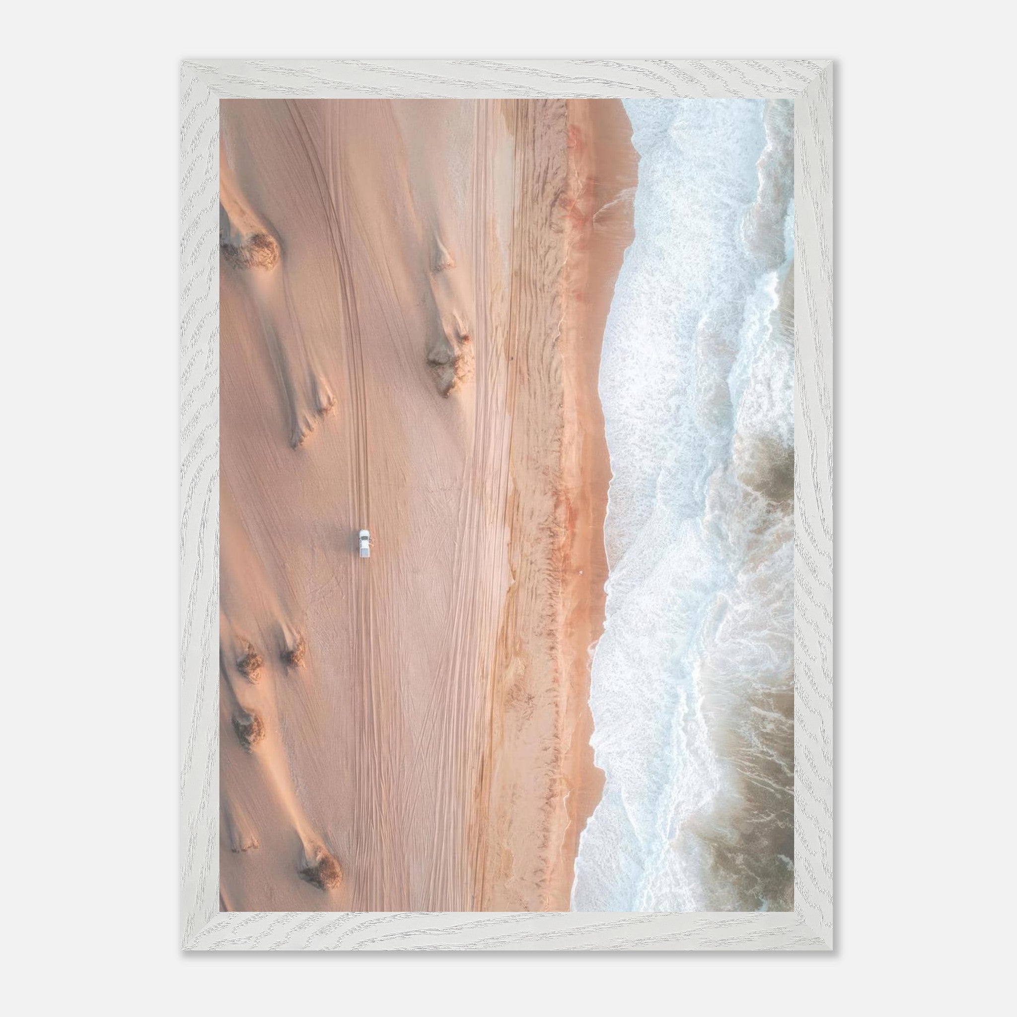 Drone photography of desert dunes meeting ocean waves in a vintage frame.