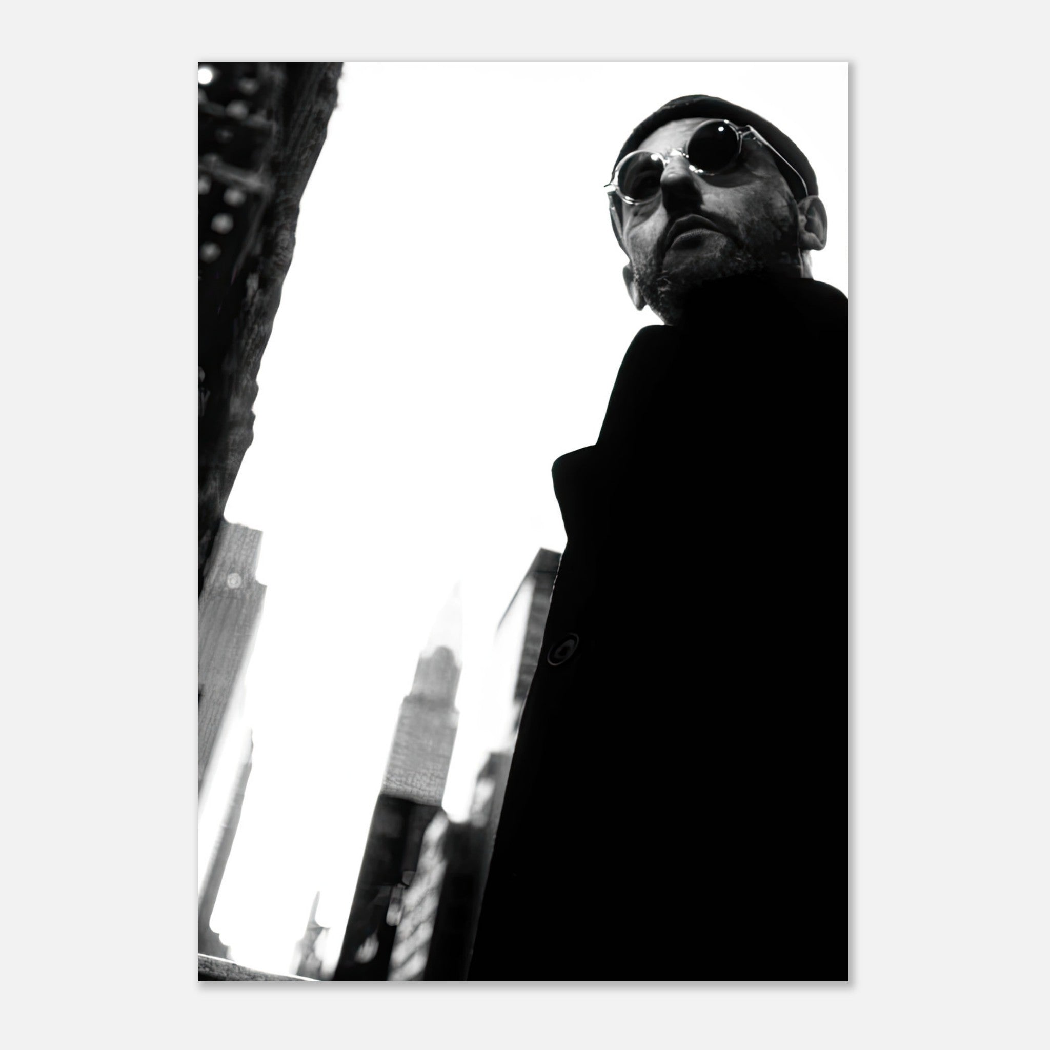 Black-and-white poster of Jean Reno in sunglasses, capturing cinematic artistry and timeless style.