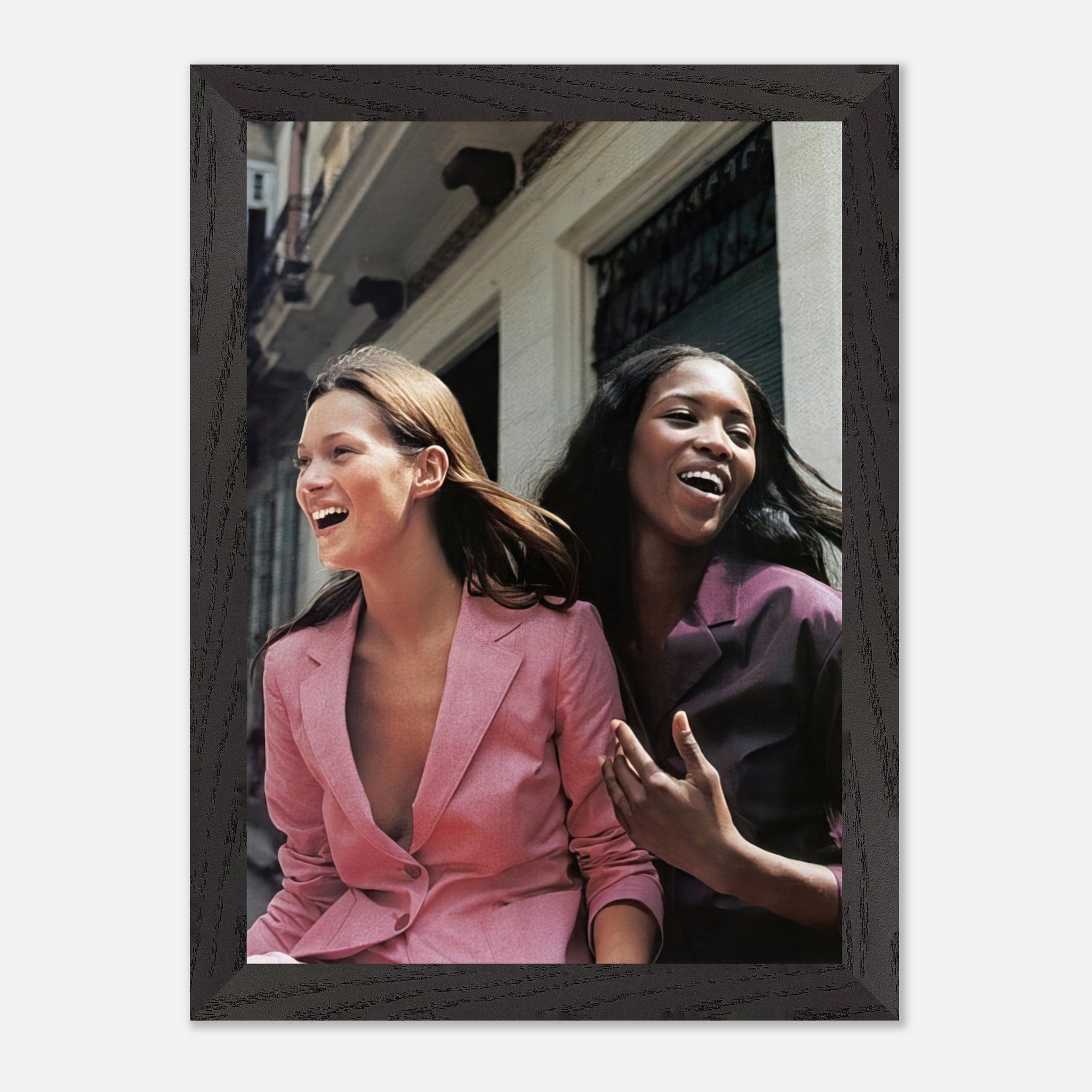 Naomi Campbell and Kate Moss laughing together in a vintage framed print, showcasing timeless fashion elegance.