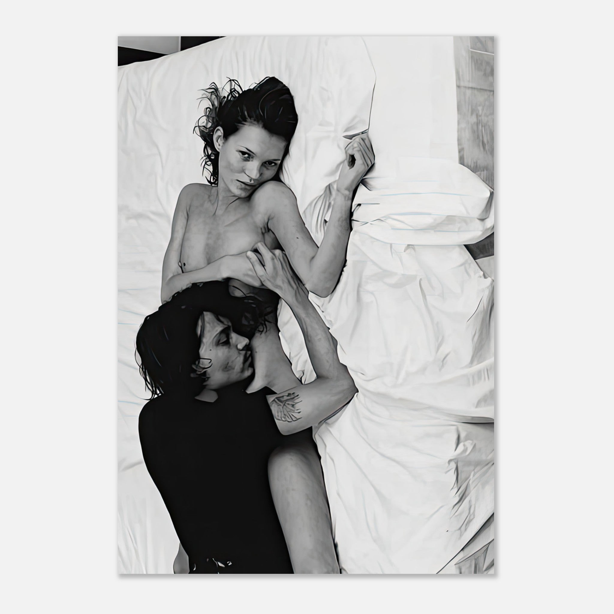 Kate Moss and Johnny Depp in an iconic 1994 black-and-white photograph, showcasing 90s romance and allure on a bed.