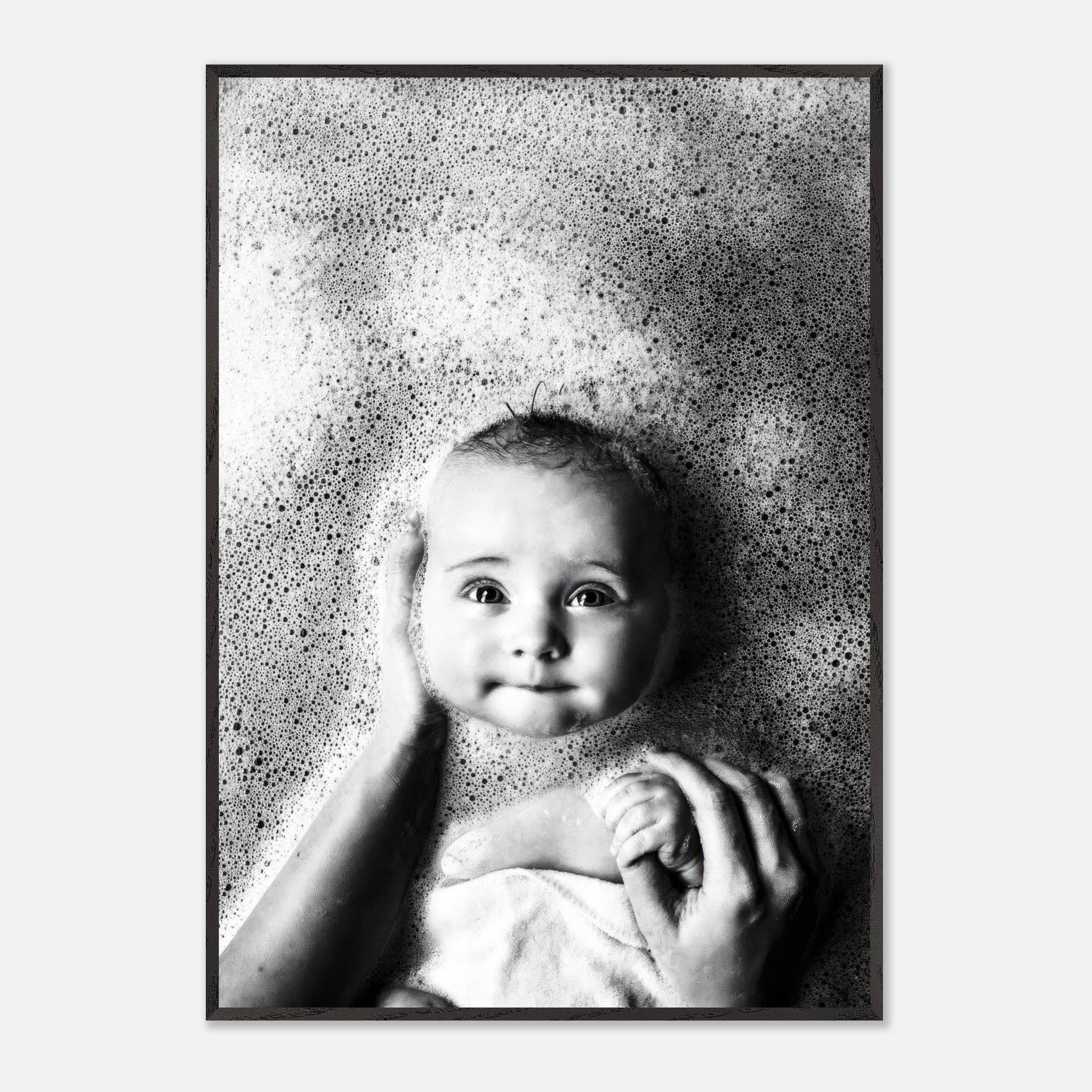 Black-and-white fine art print of a baby in a bath surrounded by bubbles, capturing innocence and joy.
