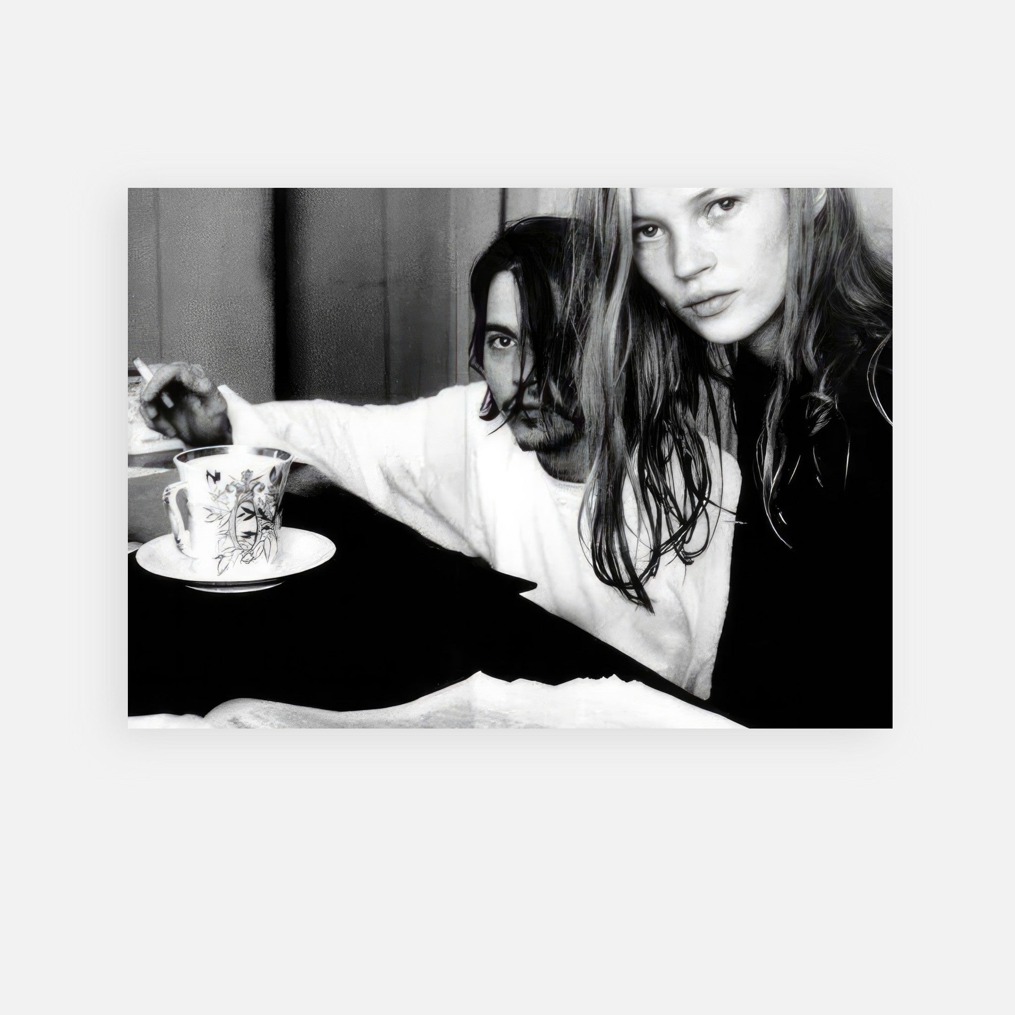Black-and-white poster of Johnny Depp and Kate Moss, embodying 90s rock-and-roll romance, shot by François-Marie Banier.