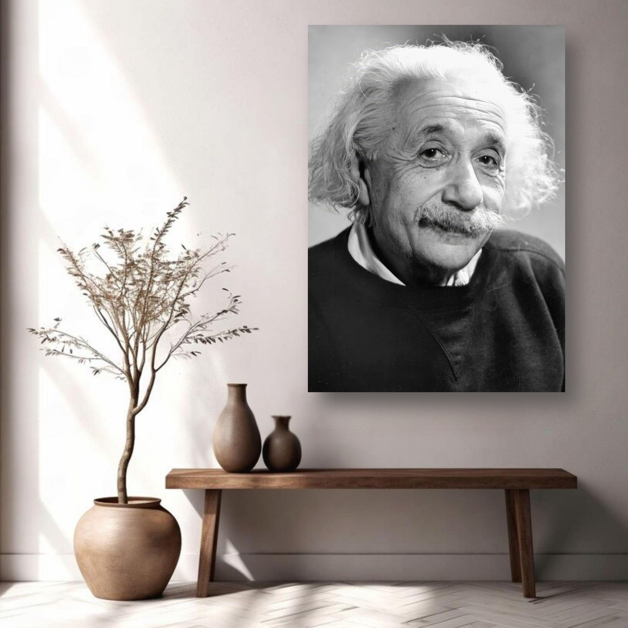 Black-and-white portrait of Albert Einstein on a wall, surrounded by minimalist decor and plants.
