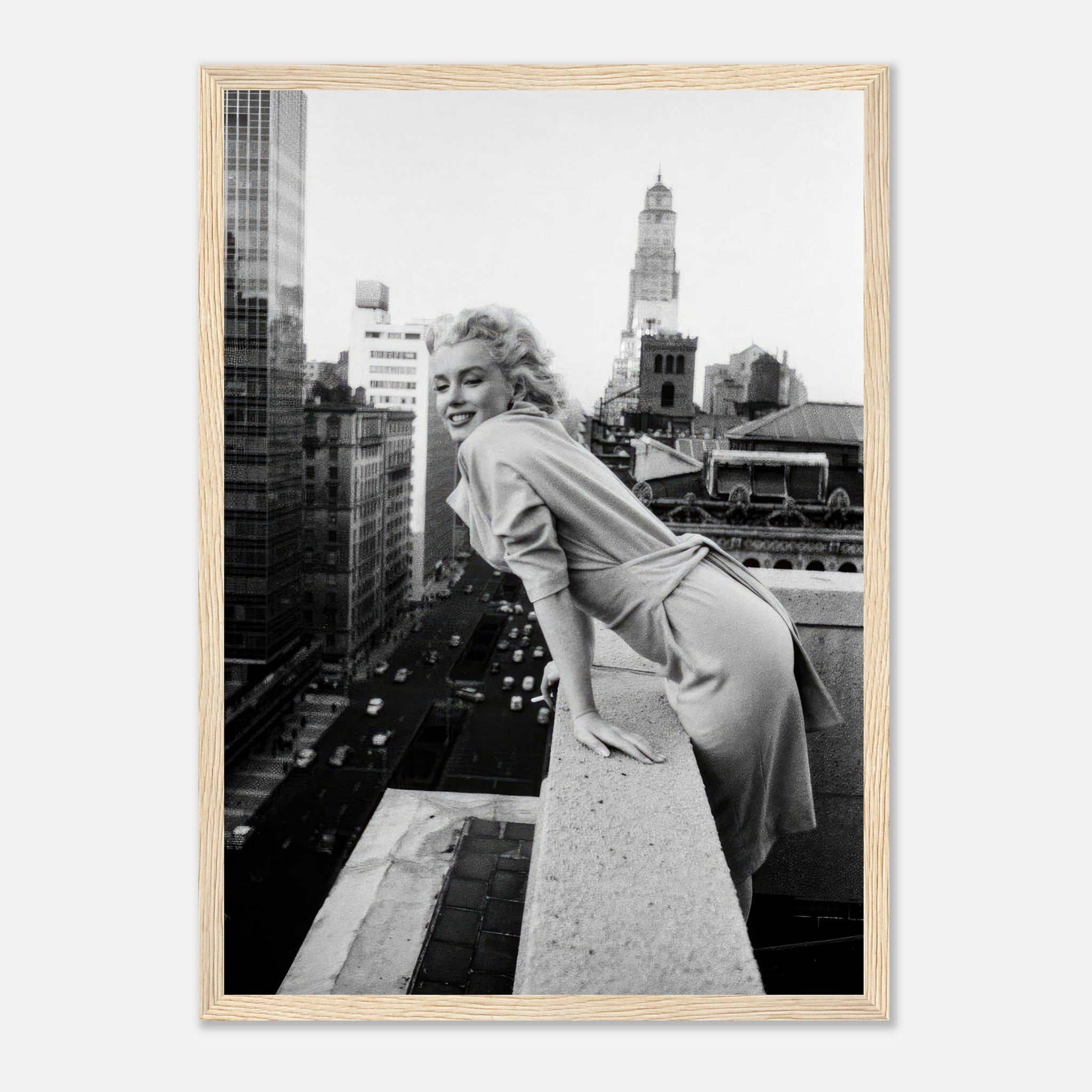 Marilyn Monroe leaning over a rooftop in 1950s New York City, framed black-and-white photograph.