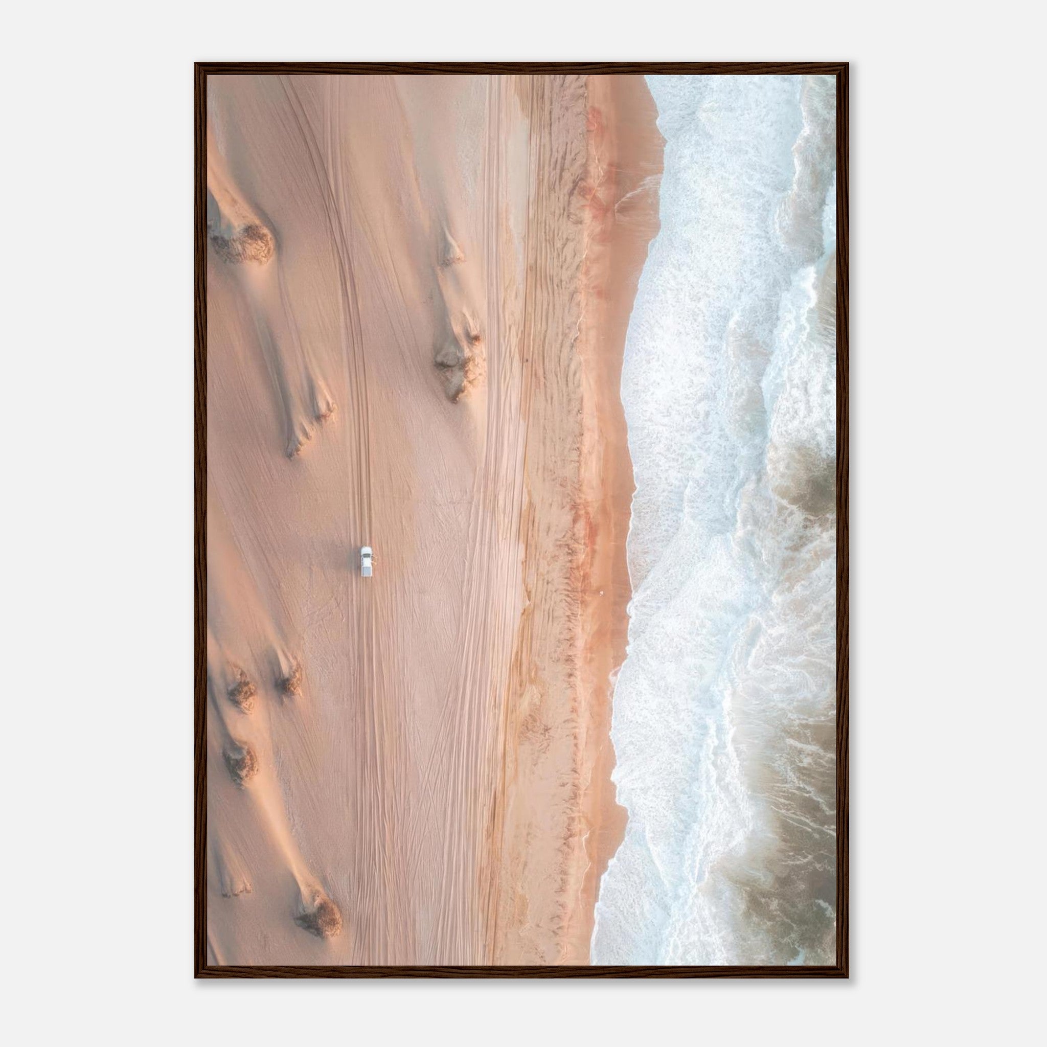 Drone photography of desert meeting ocean, showcasing sand dunes and crashing waves in a stunning framed print.