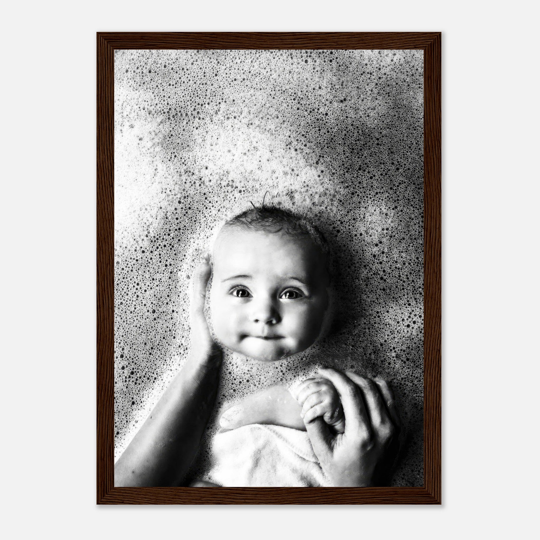 Black-and-white framed print of a baby in a bubble bath, capturing innocence and joy during bath time.