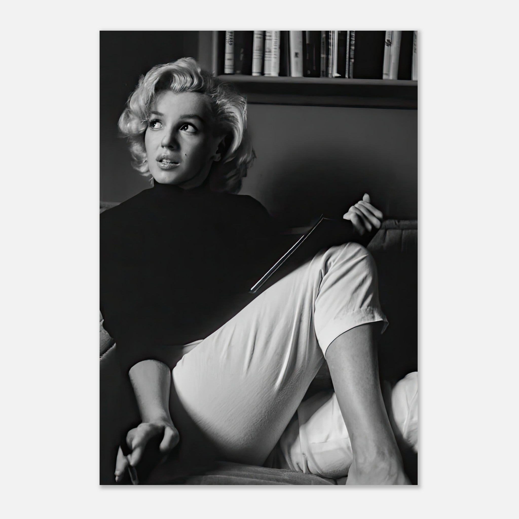 Marilyn Monroe in black and white, thoughtfully reading, showcased in a high-quality metal print.