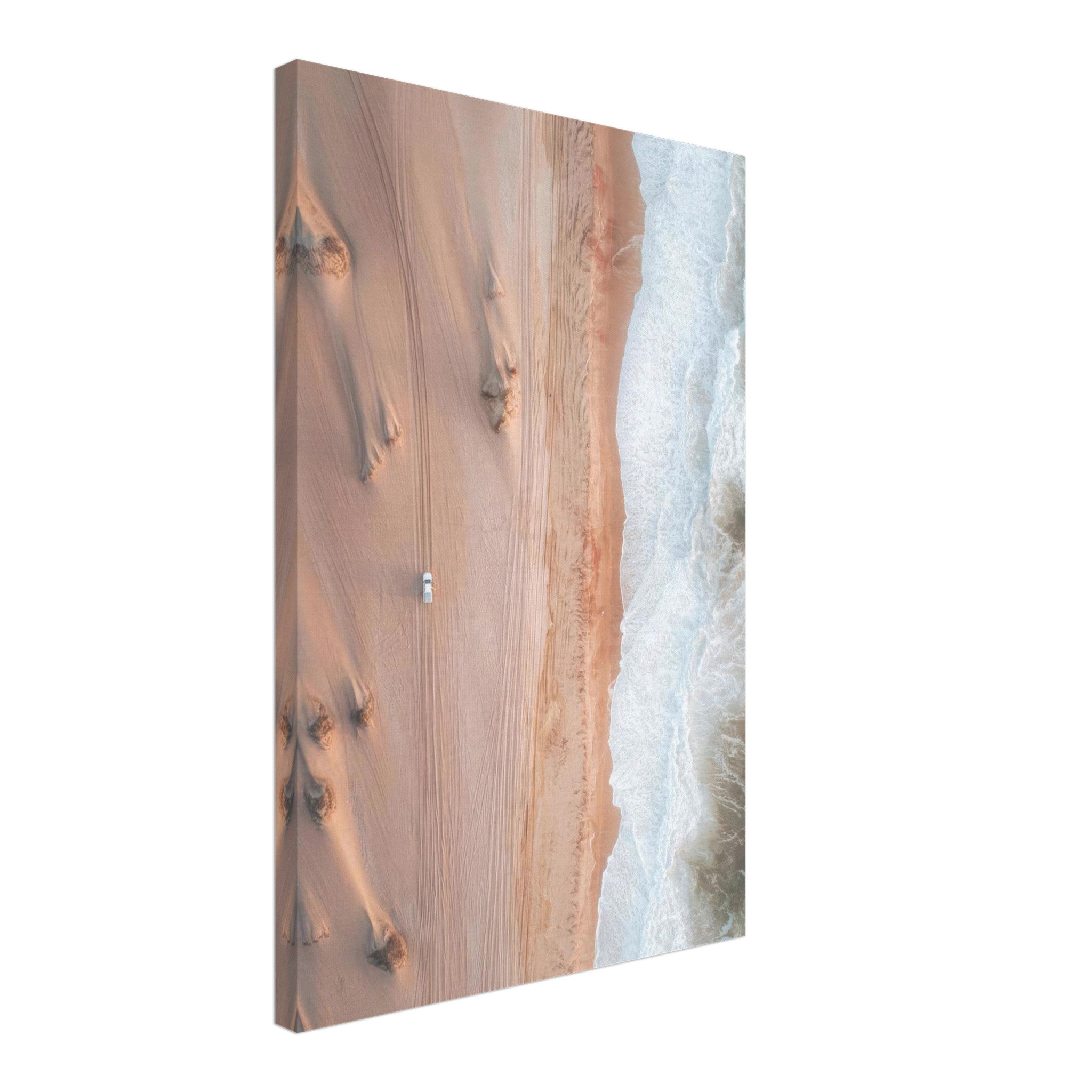 Stunning aerial view of desert sand dunes meeting ocean waves, captured in a canvas print.
