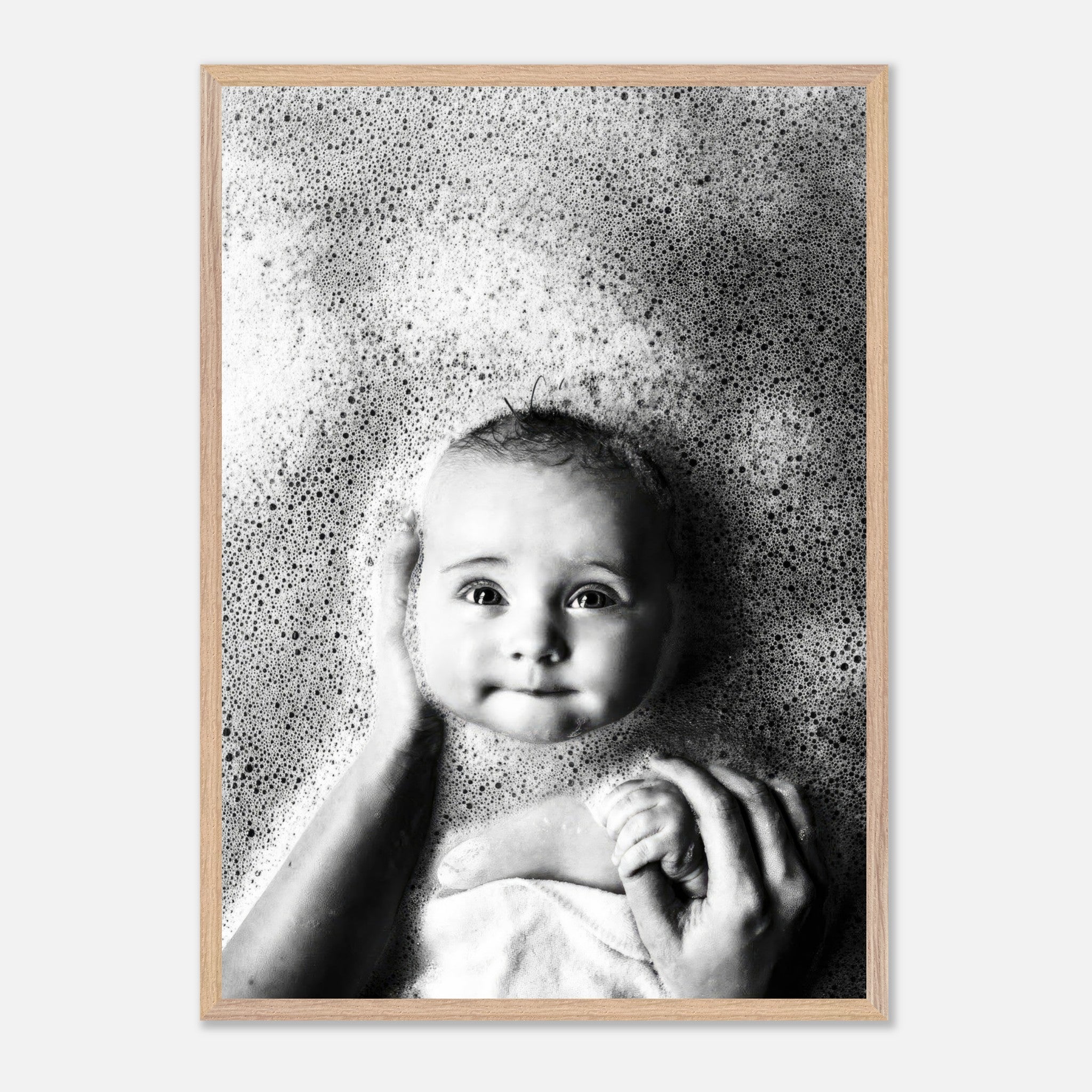 Vintage framed print of a smiling baby in bubbles, capturing the innocence of childhood in black and white.