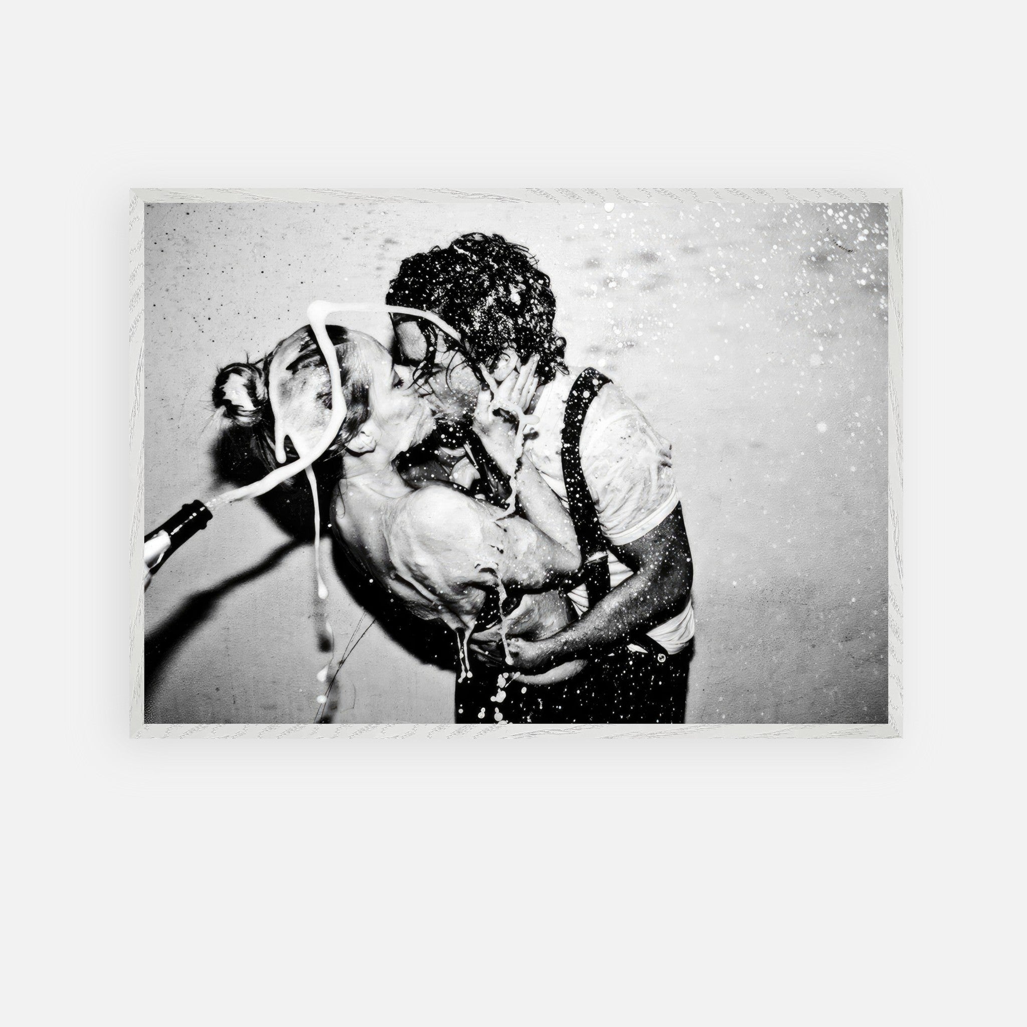 The Champagne Kiss vintage framed art featuring Johnny Depp and Kate Moss celebrating passionately in black-and-white.